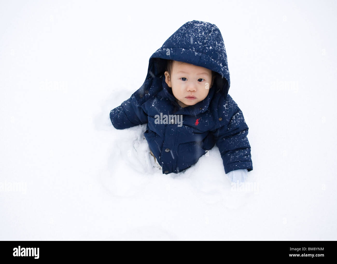 Asian baby boy in snow Foto Stock