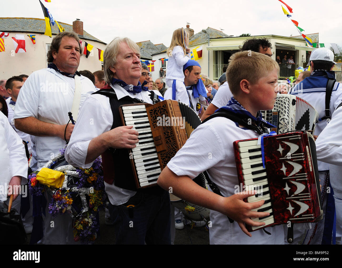 I seguaci del blue oss marciando attraverso le strade di padstow, Cornwall su obby oss giorno Foto Stock