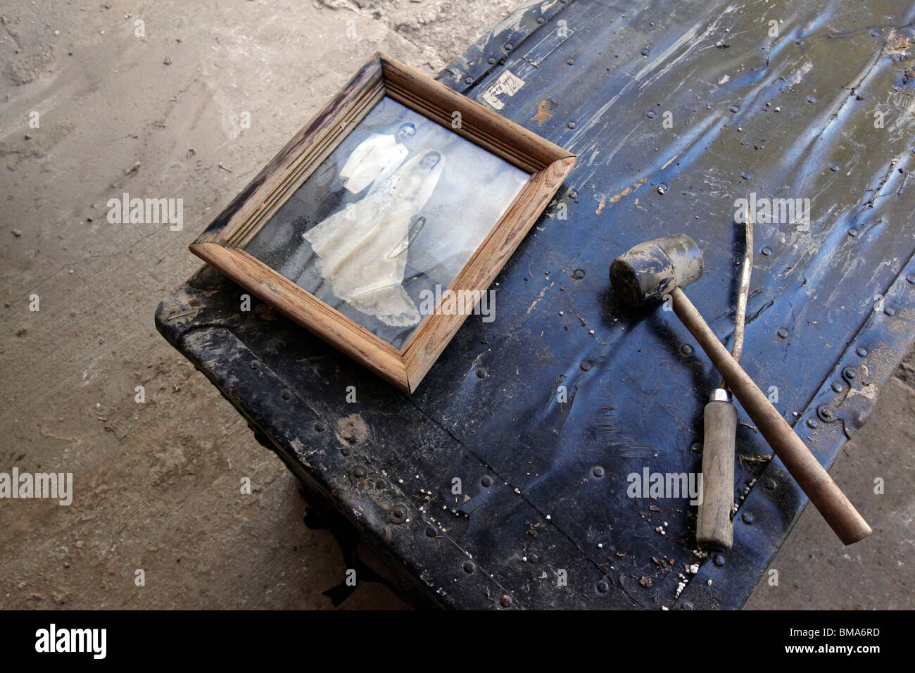 Un acqua-danneggiato fotografia di Barbara Earl del ritardo di marito e moglie prima giace su un danneggiamento del torace in una casa eviscerati. Foto Stock