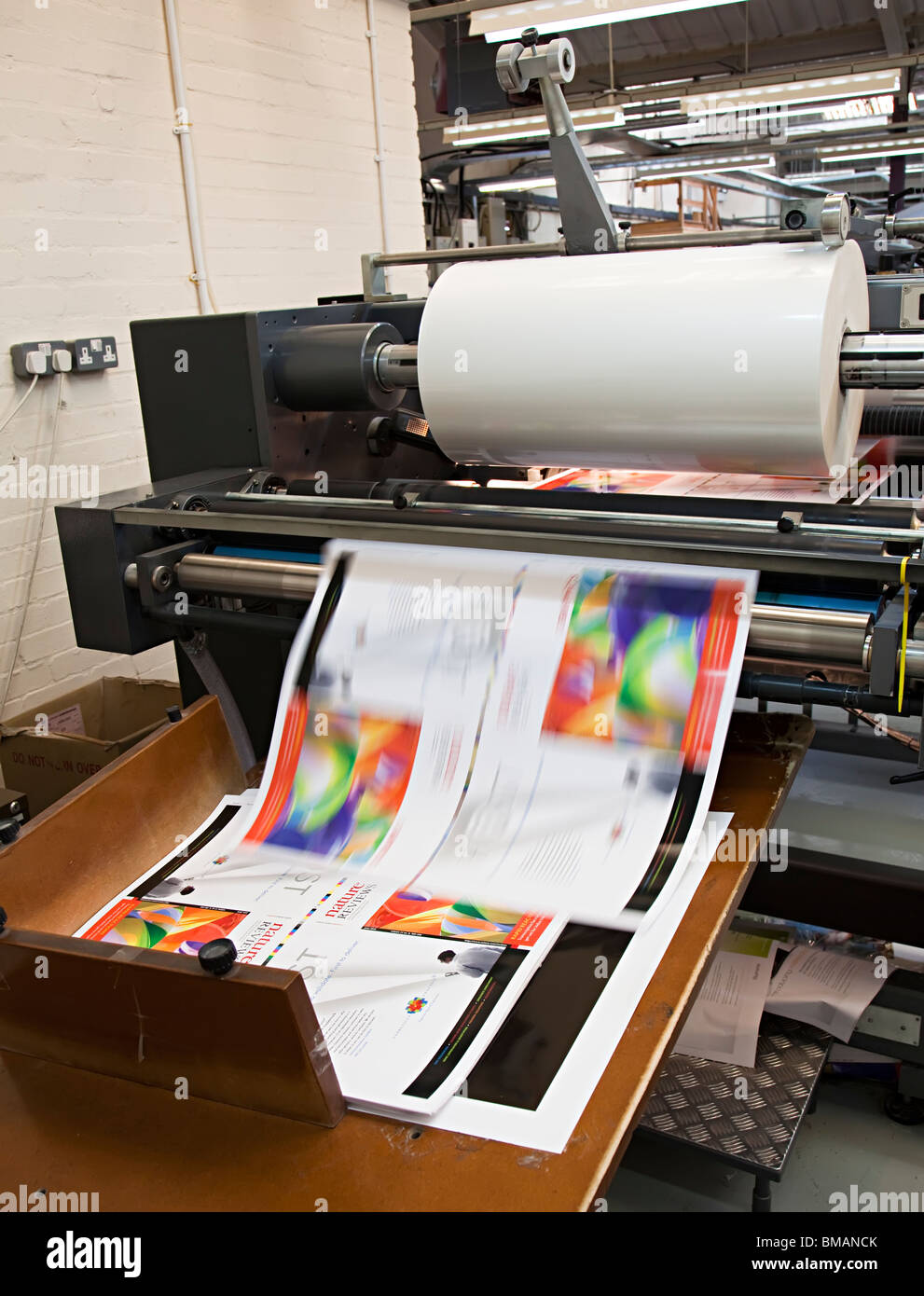 Macchina di laminazione con foglio laminato di carta velocizzando il roll off Wales UK Foto Stock