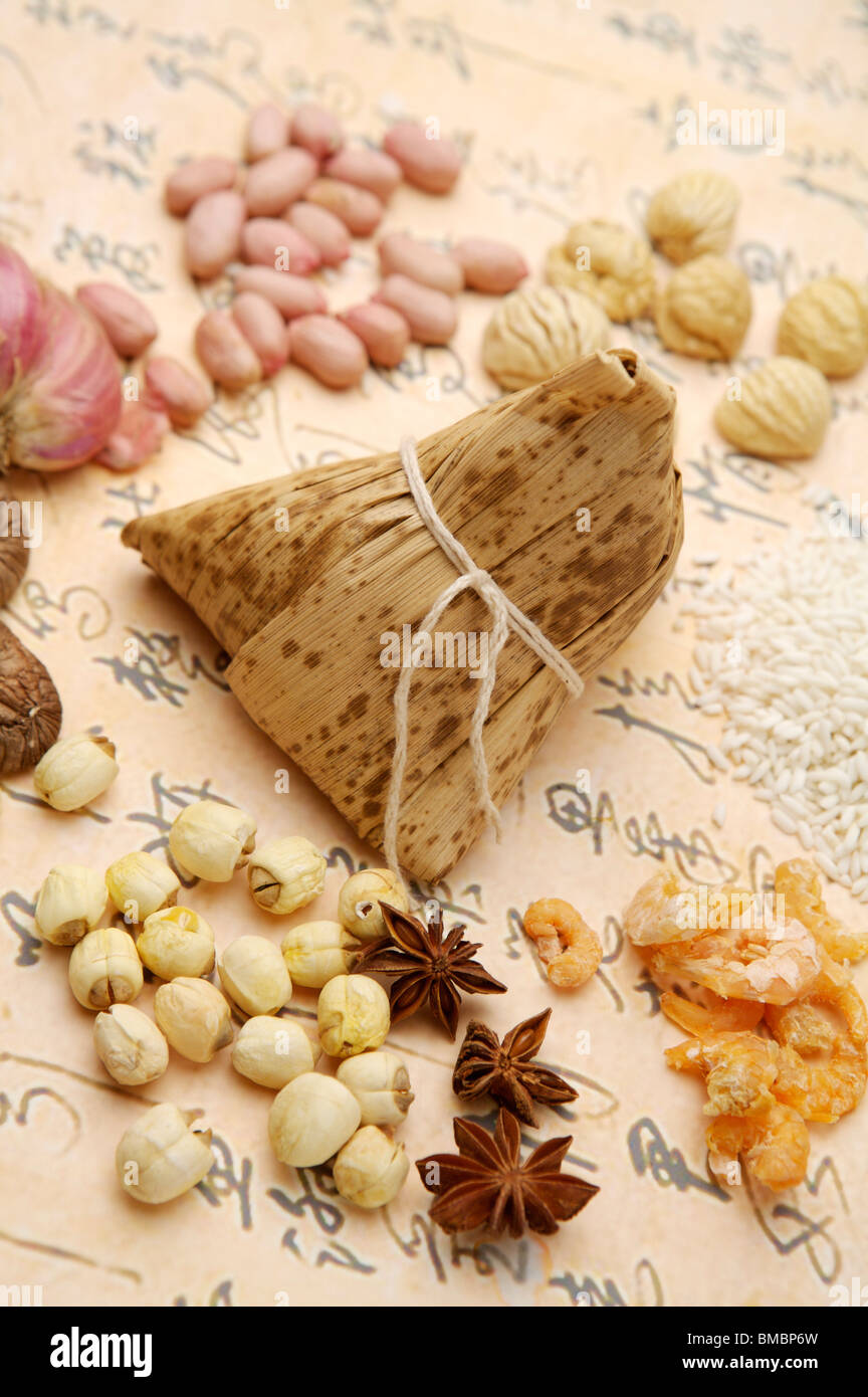 Cinese gnocco di riso e ingredienti con la calligrafia cinese come sfondo Foto Stock