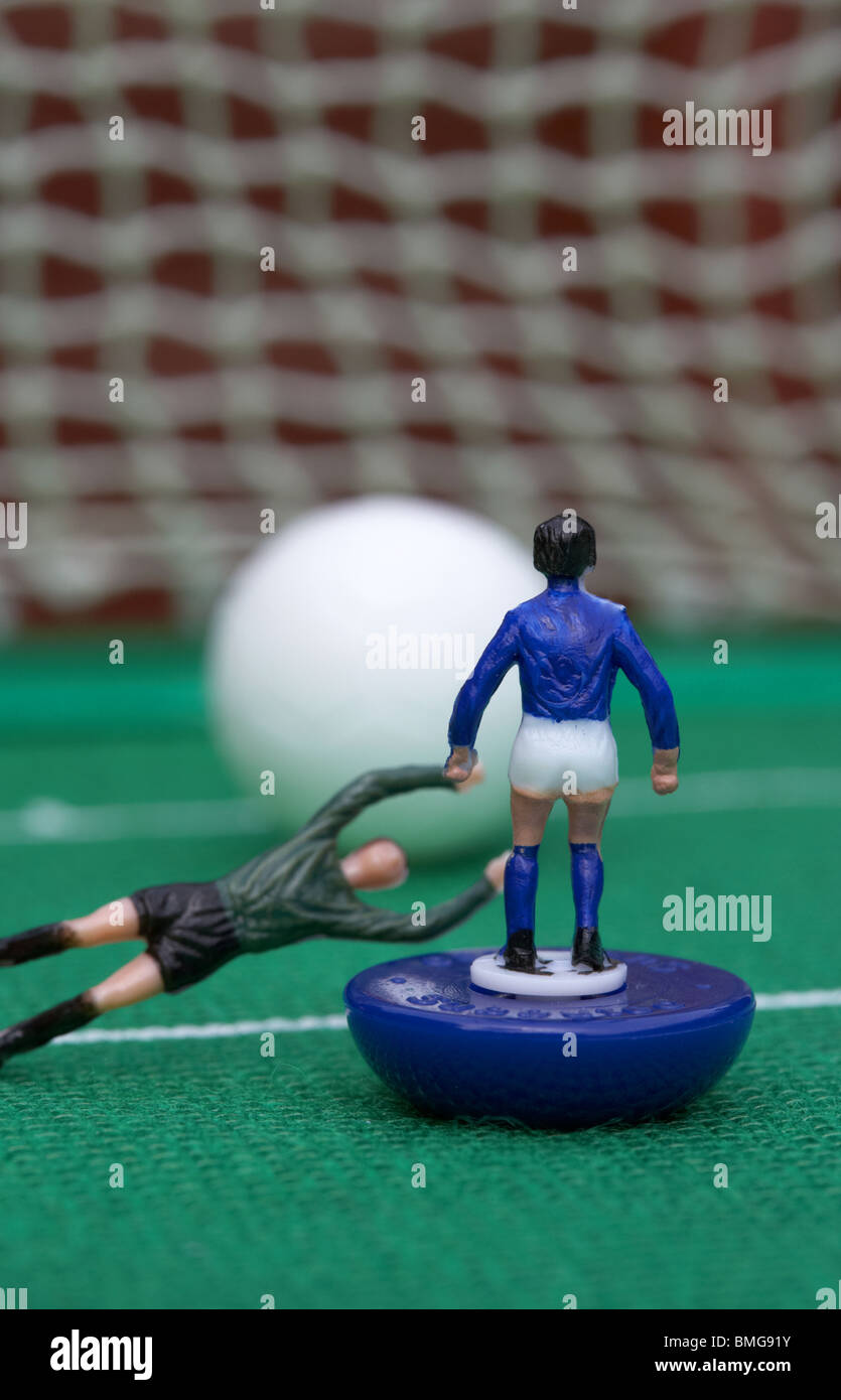 Il portiere immersioni il fallo player nella casella football soccer reinacted scena con Subbuteo® table top football giocatori gioco Foto Stock Il portiere immersioni il fallo player nella casella football soccer reinacted scena con Subbuteo® table top football giocatori gioco Foto Stock