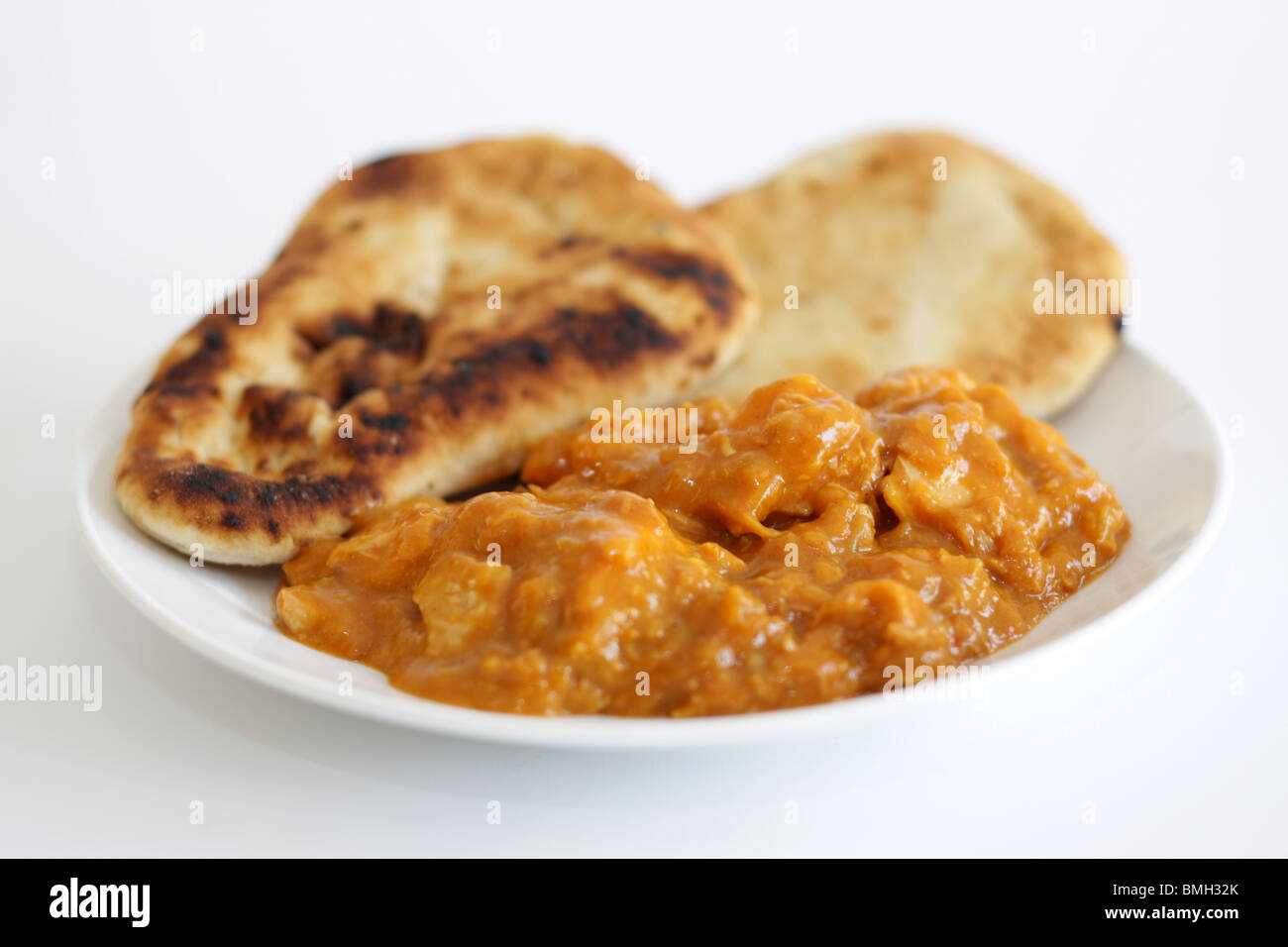 Pollo al curry e pane naan Foto Stock