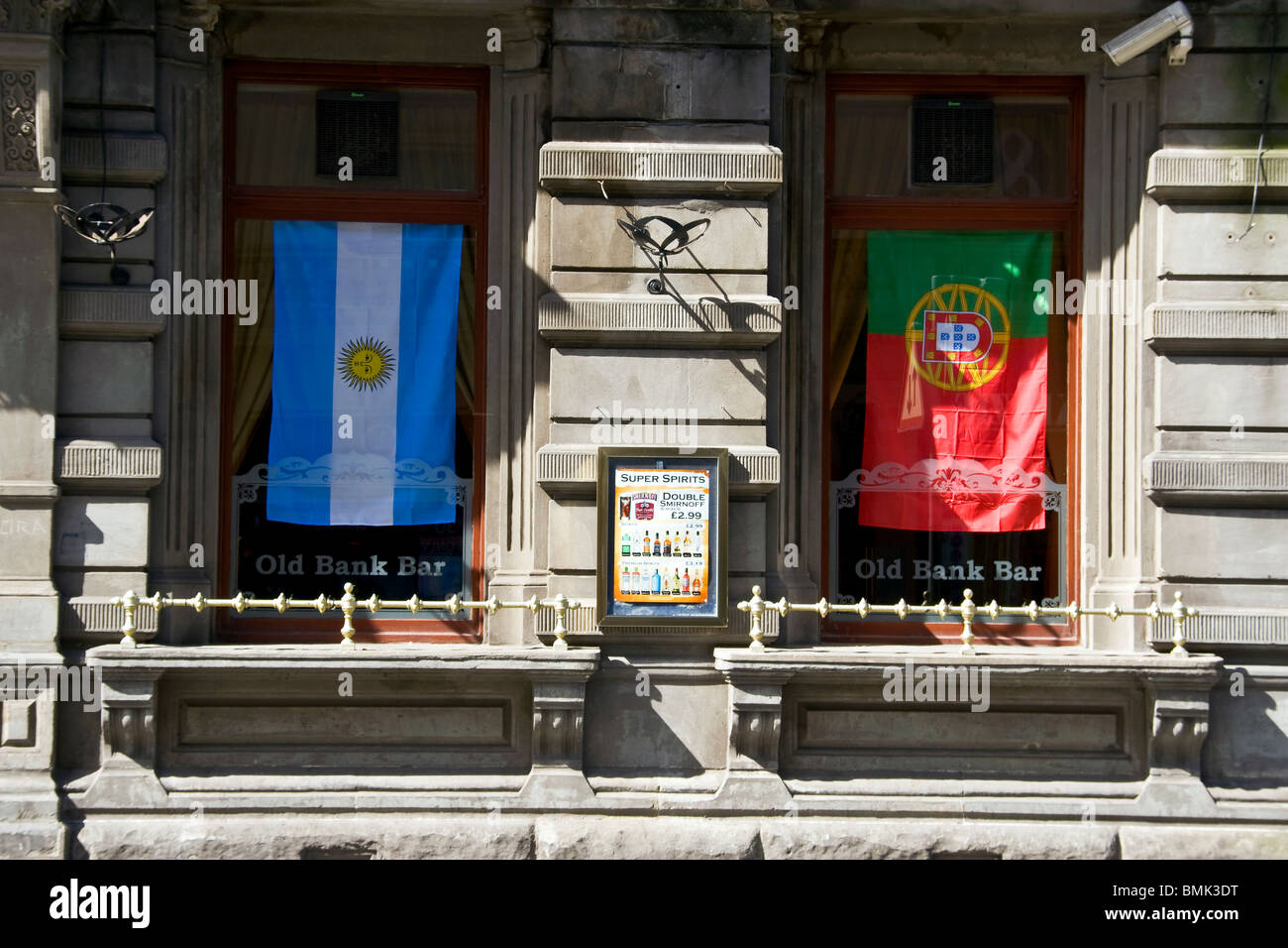 La vecchia banca Bar con due bandiere internazionali drappeggiato sopra le finestre la pubblicità dei loro Live TV mostra della Coppa del Mondo 2010 Foto Stock
