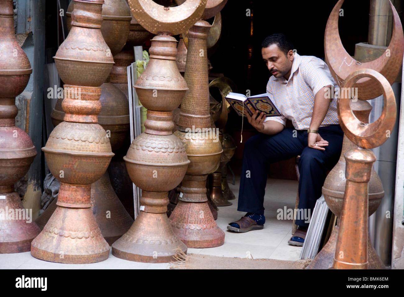 L'uomo della lettura in rame al souk Khan al-Khalili Bazaar, Cairo, Al Qahirah, Egitto Foto Stock