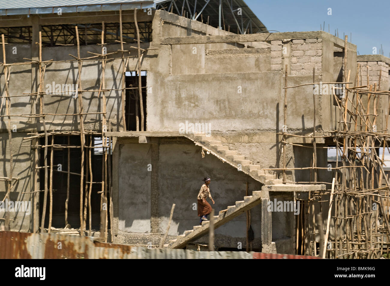 Una donna in un mantello marrone passeggiate in concreti passi presso il  cantiere per la costruzione di un edificio in Etiopia ad Addis Abeba,  Africa Foto stock - Alamy