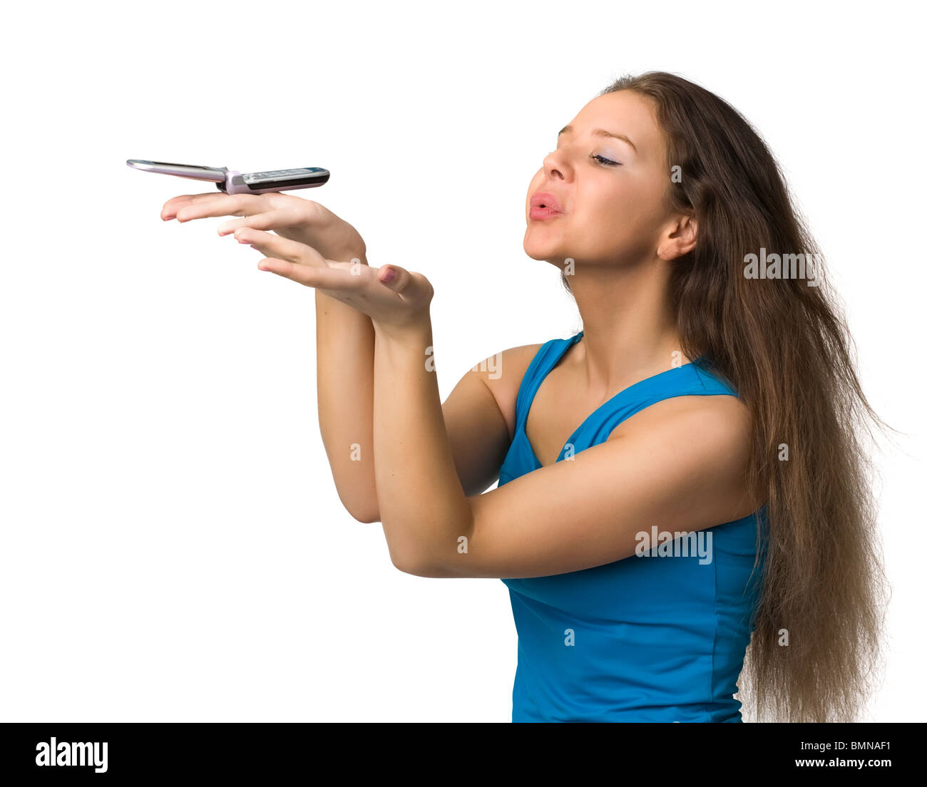 Bella ragazza possiede un telefono cellulare su un Palm e la soffia, isolato su bianco Foto Stock