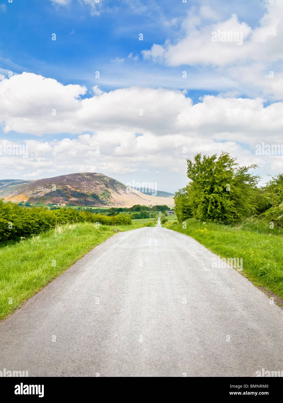 Long Road - strada di campagna aperta nel Lake District inglese, Cumbria, Inghilterra, Regno Unito Foto Stock