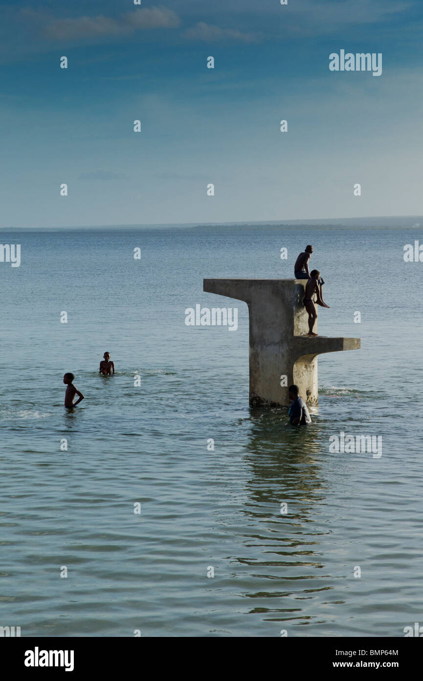 Gli adolescenti locali le immersioni in mare di Inhambane, Mozambico, Africa. Foto Stock