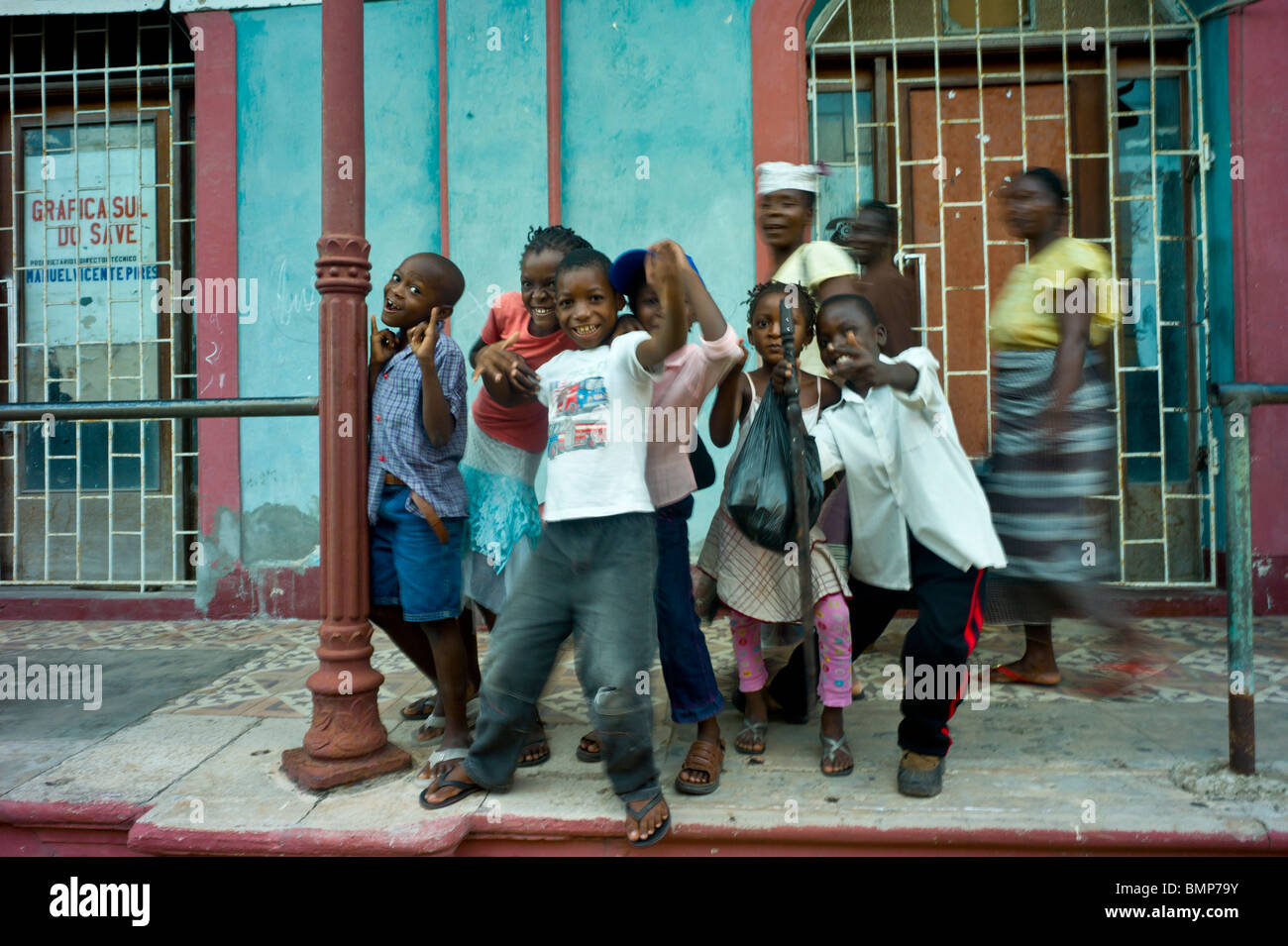 I bambini nella strada di fronte a una tipografia store di Inhambane, Mozambico, Africa Foto Stock