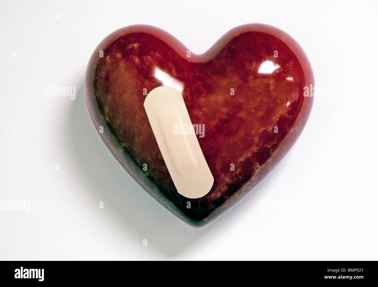 Cuore con il cerotto Foto Stock