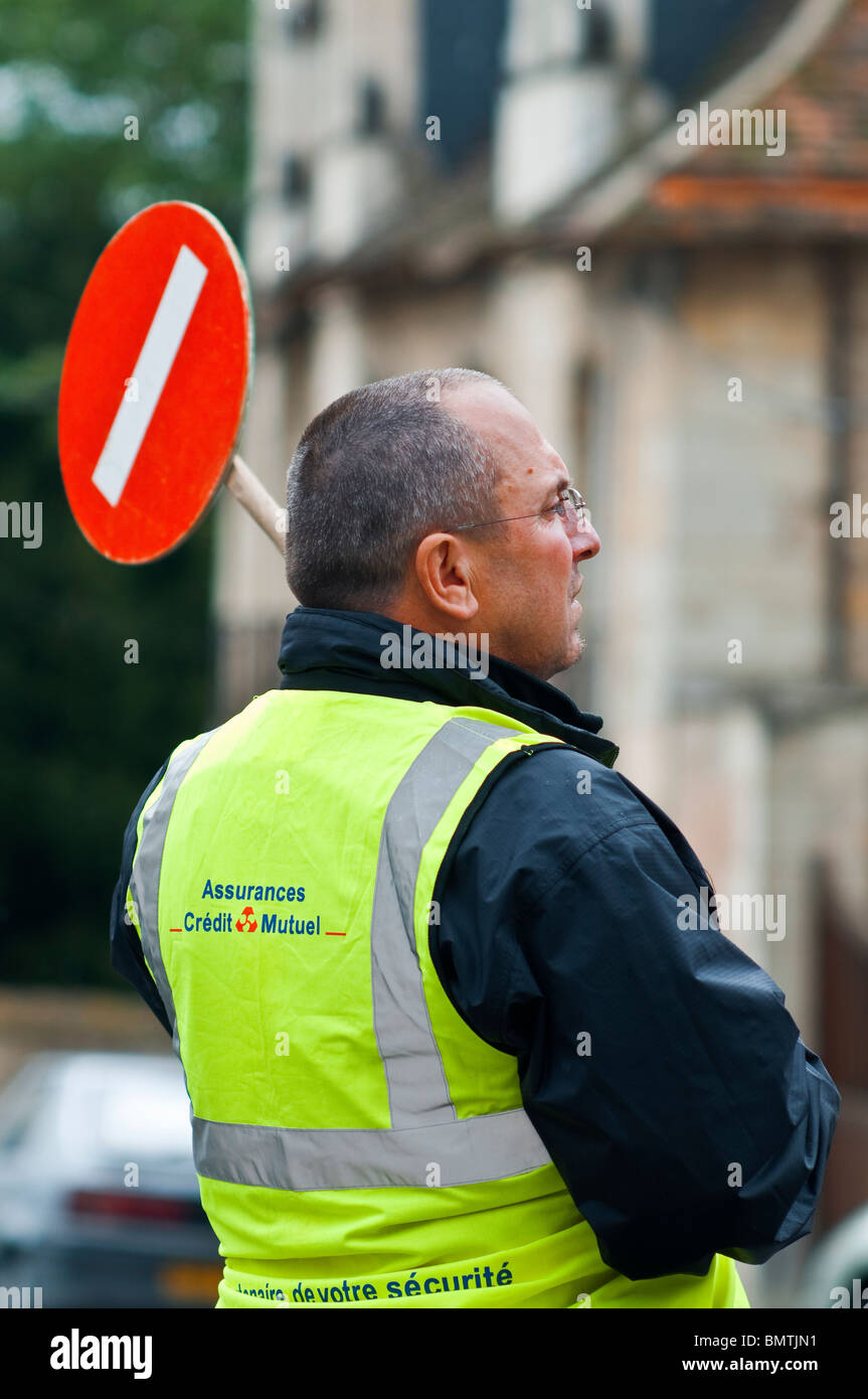 Uomo con la temporanea interruzione segno durante la gara ciclistica - Francia. Foto Stock