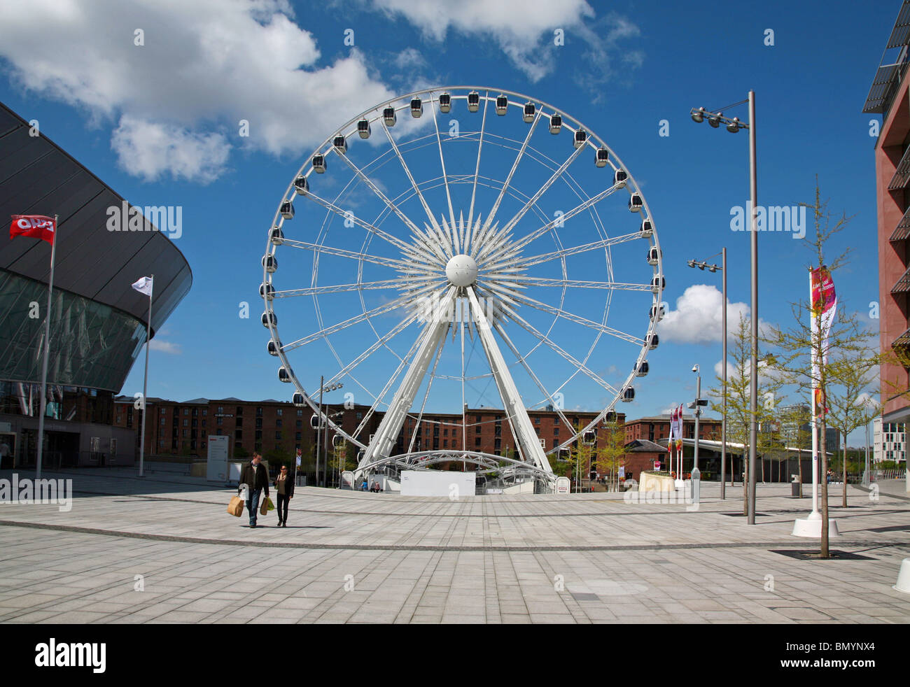 La grande ruota panoramica di fronte all'ingresso di Albert Dock una grande attrazione turistica della città di Liverpool Foto Stock