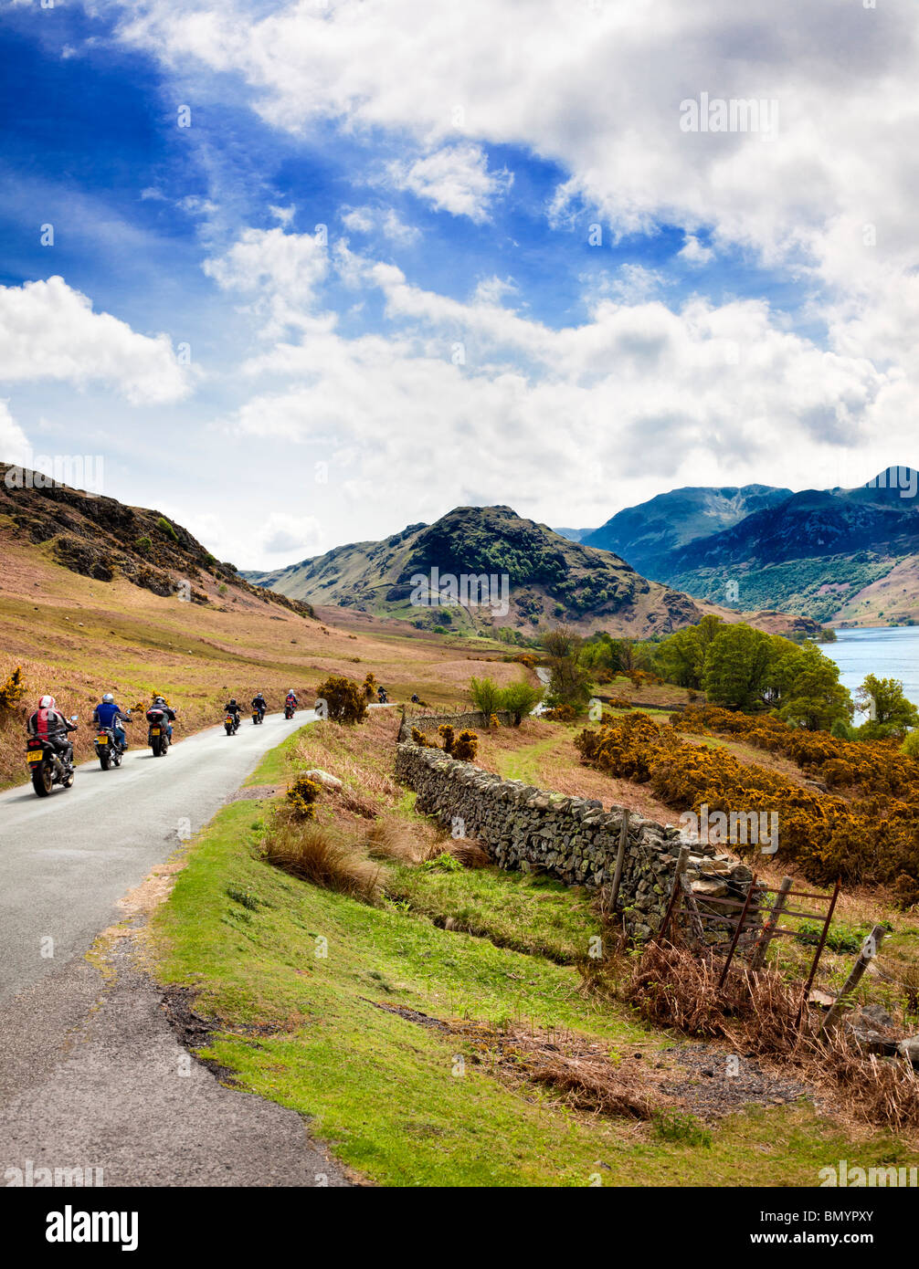 Motociclisti o motociclette che visitano il Lake District in un viaggio su strada passando per Crummock Water, Lake District, Inghilterra, Regno Unito Foto Stock