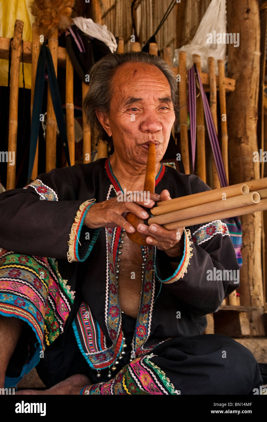 L'uomo la riproduzione di un tipo di flauto al Baan Tong Luang, villaggio del popolo Hmong nelle zone rurali a Chiang Mai provincia, Thailandia. Foto Stock