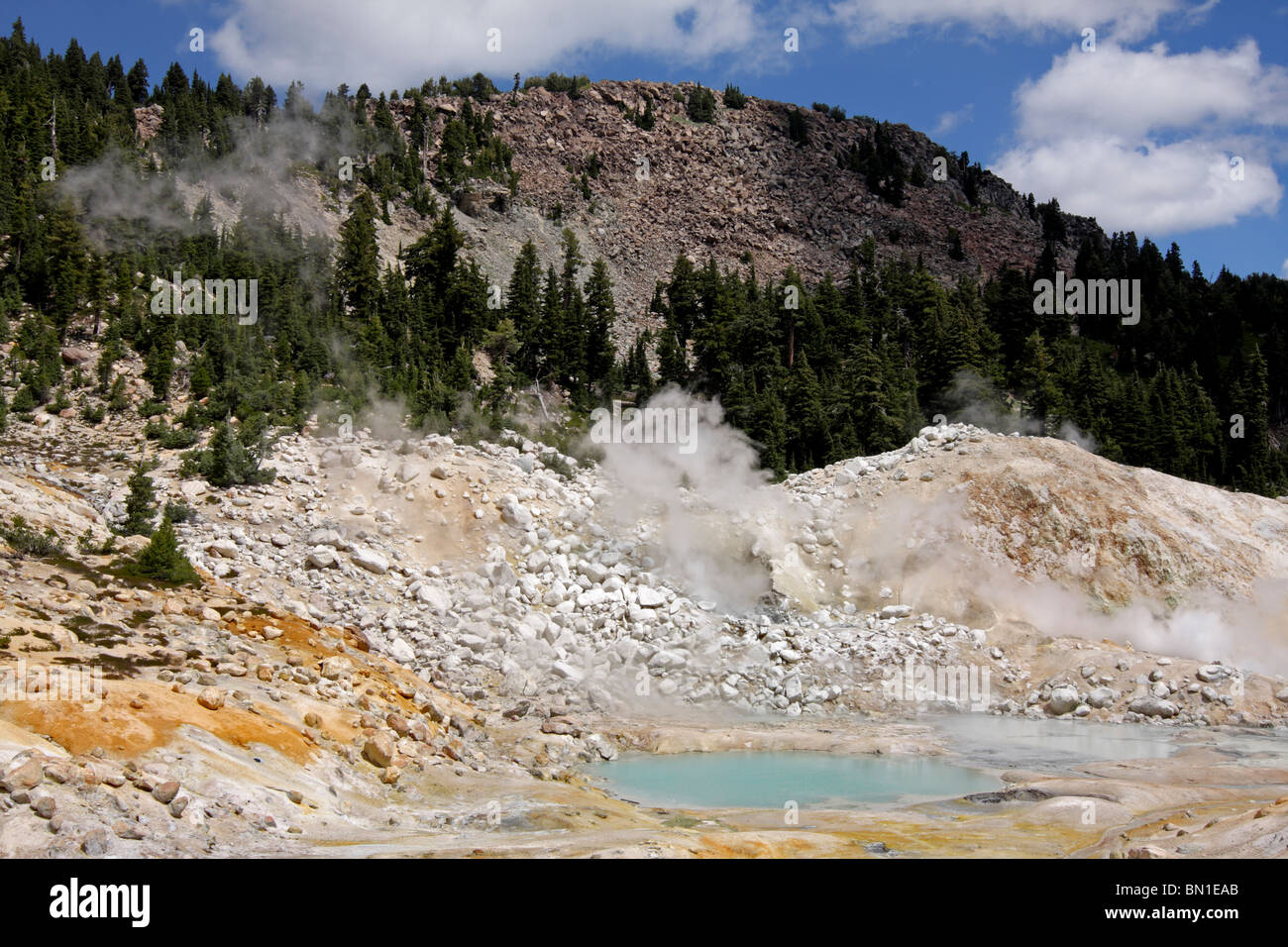 Vapore sorge dalle fumarole accanto alle piscine di ebollizione nel Bumpass Hell area geotermica di Parco Nazionale vulcanico di Lassen. Foto Stock