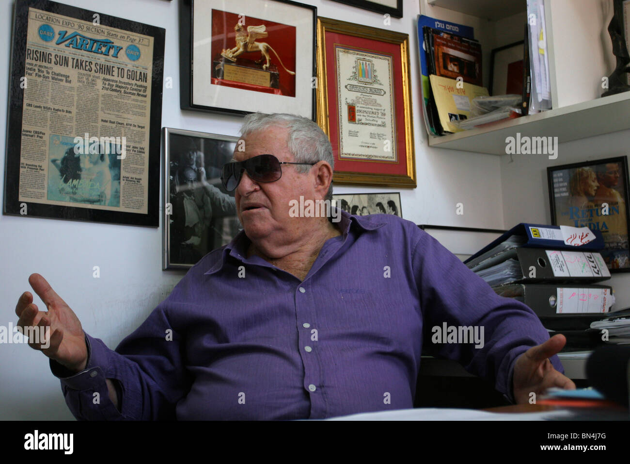 Produttore israeliano e direttore Menahem Golan è guardando i suoi molti premi e riconoscimenti, appeso al muro del suo ufficio in Tel Aviv. Foto Stock