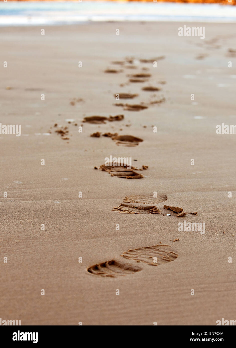 Catena di impronte sulla sabbia di mare. piccola impugnatura Foto Stock