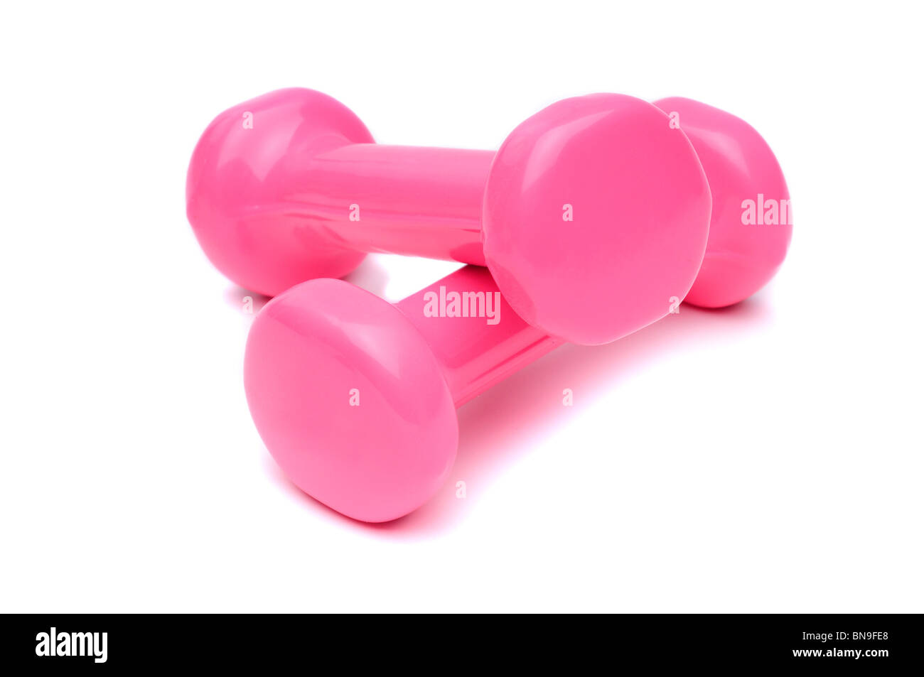 Una coppia di piccoli pesi rosa per le donne di allenamento con Foto Stock