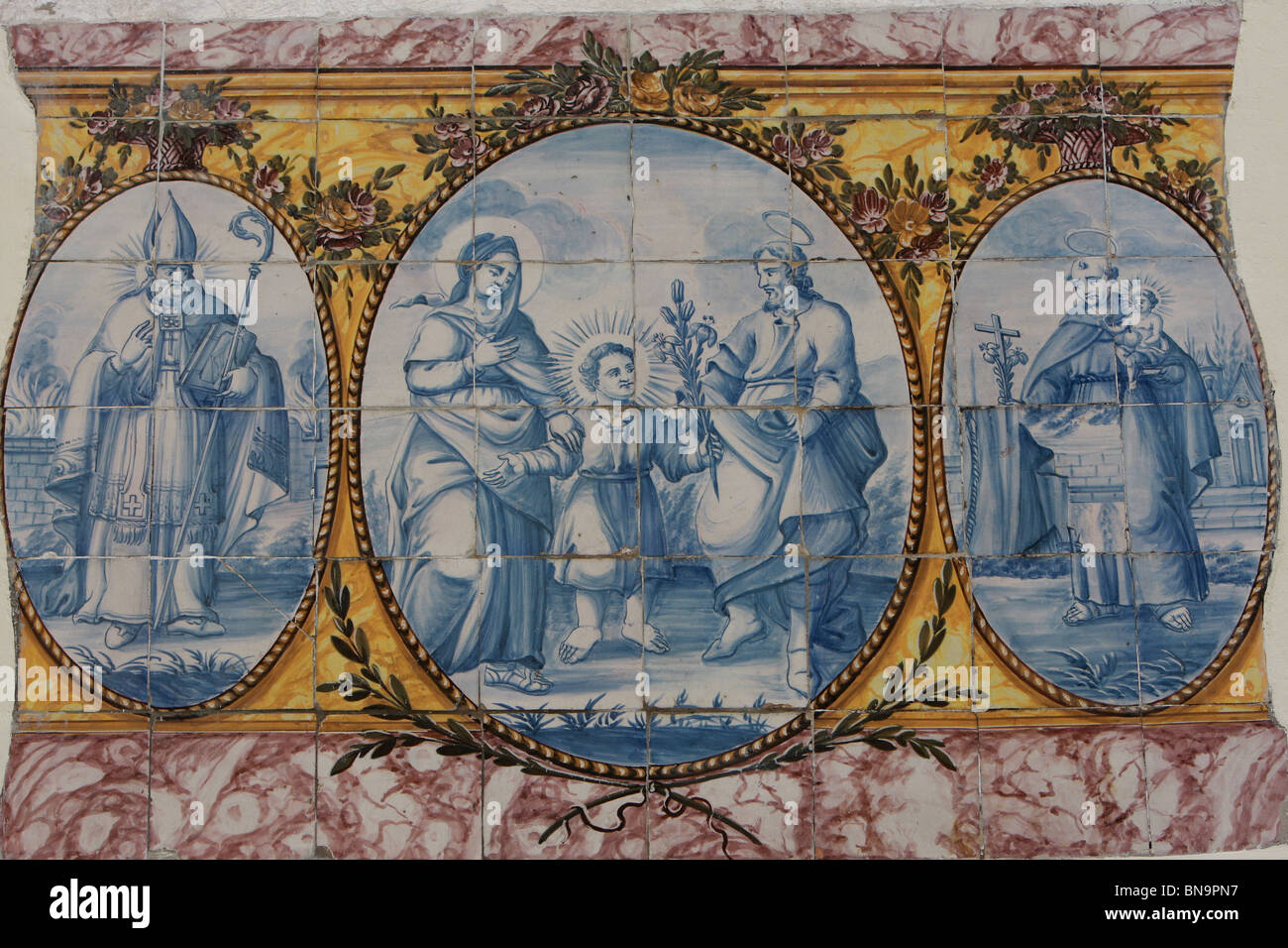 Piastrelle Azuelejo raffiguranti Gesù, Maria e Giuseppe & St Anthony su una casa nel quartiere di Alfama di Lisbona, Portogallo Foto Stock