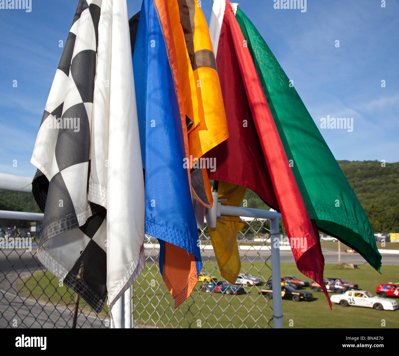 Woodstock, New Hampshire - Segnale bandiere sul segnalatore di supporto durante la stock car racing di White Mountain Motorsports Park. Foto Stock