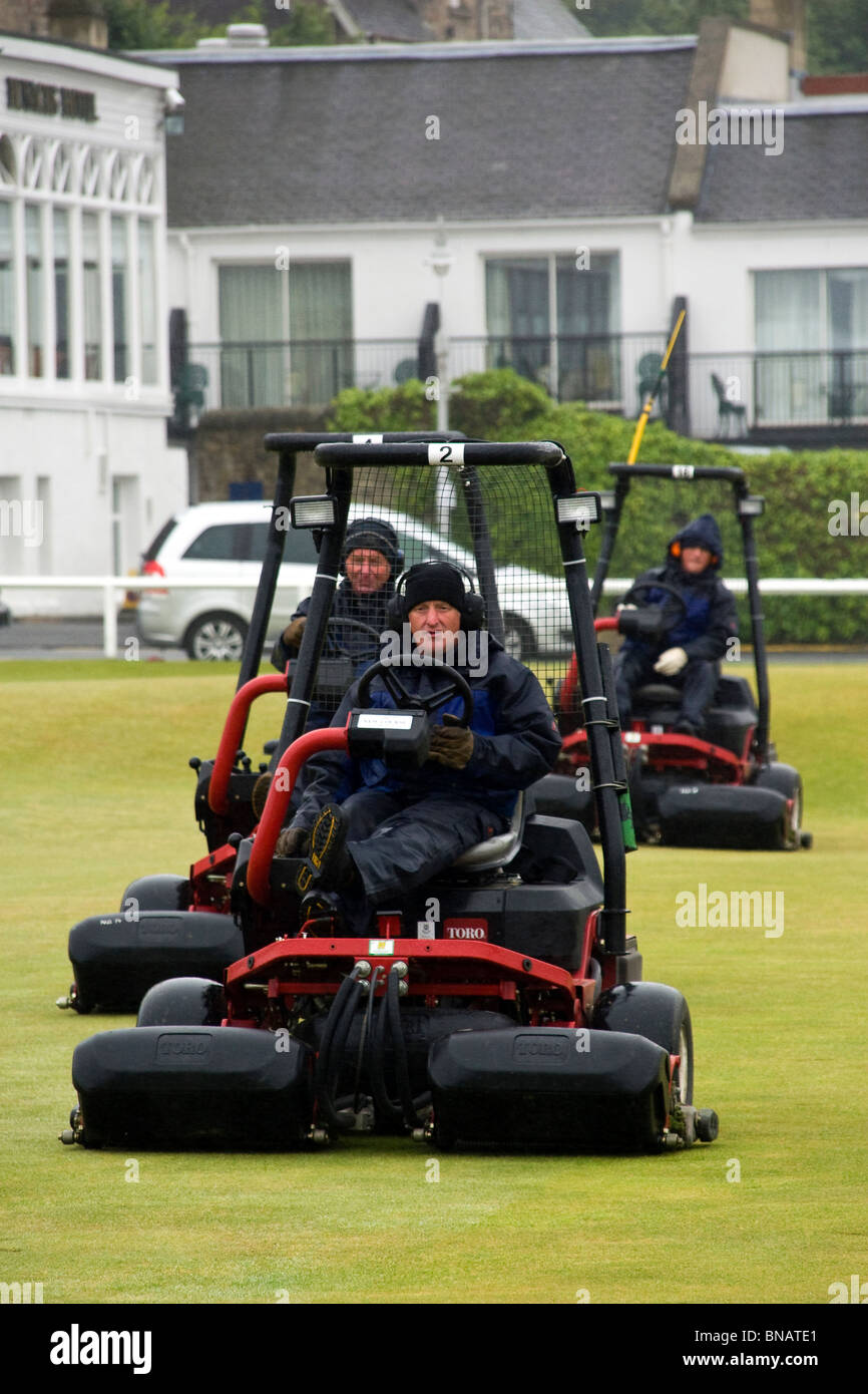 Custodi di verde con grandi falciatrici in azione preparare i verdi per il British Open di golf di 2010 a St Andrews Foto Stock