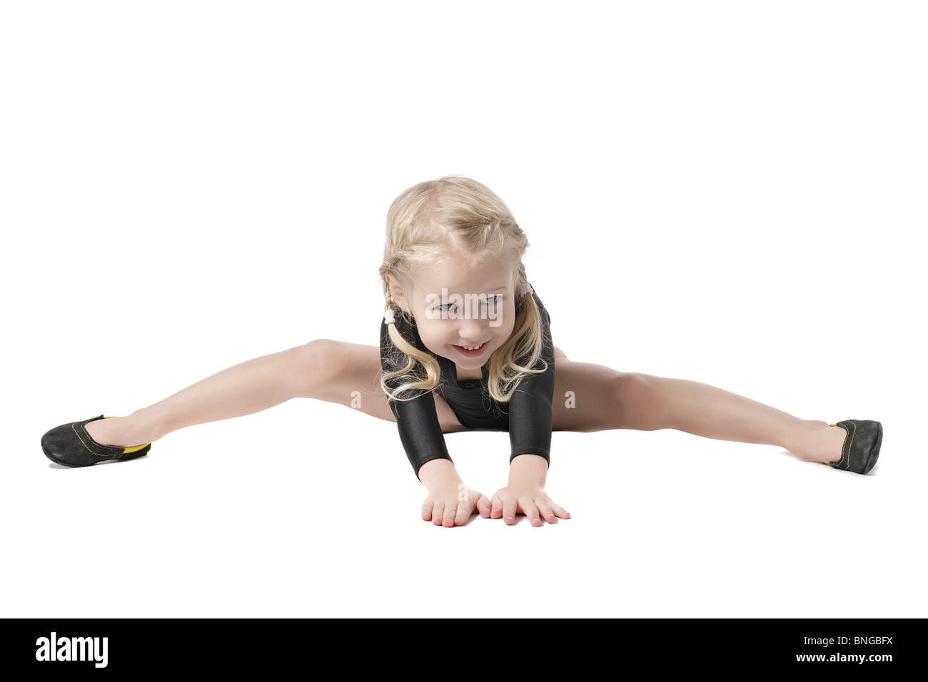 Bambina in body per ginnastica ritmica cercando di fare i gruppi isolati su bianco Foto Stock