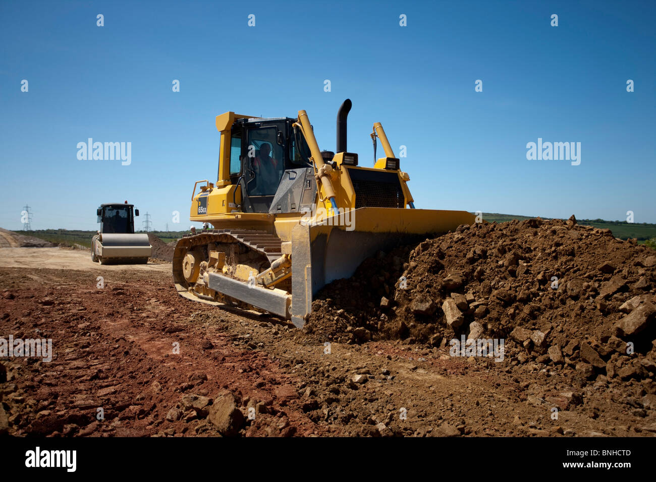 Bulldozer su strada sito in costruzione. Foto Stock