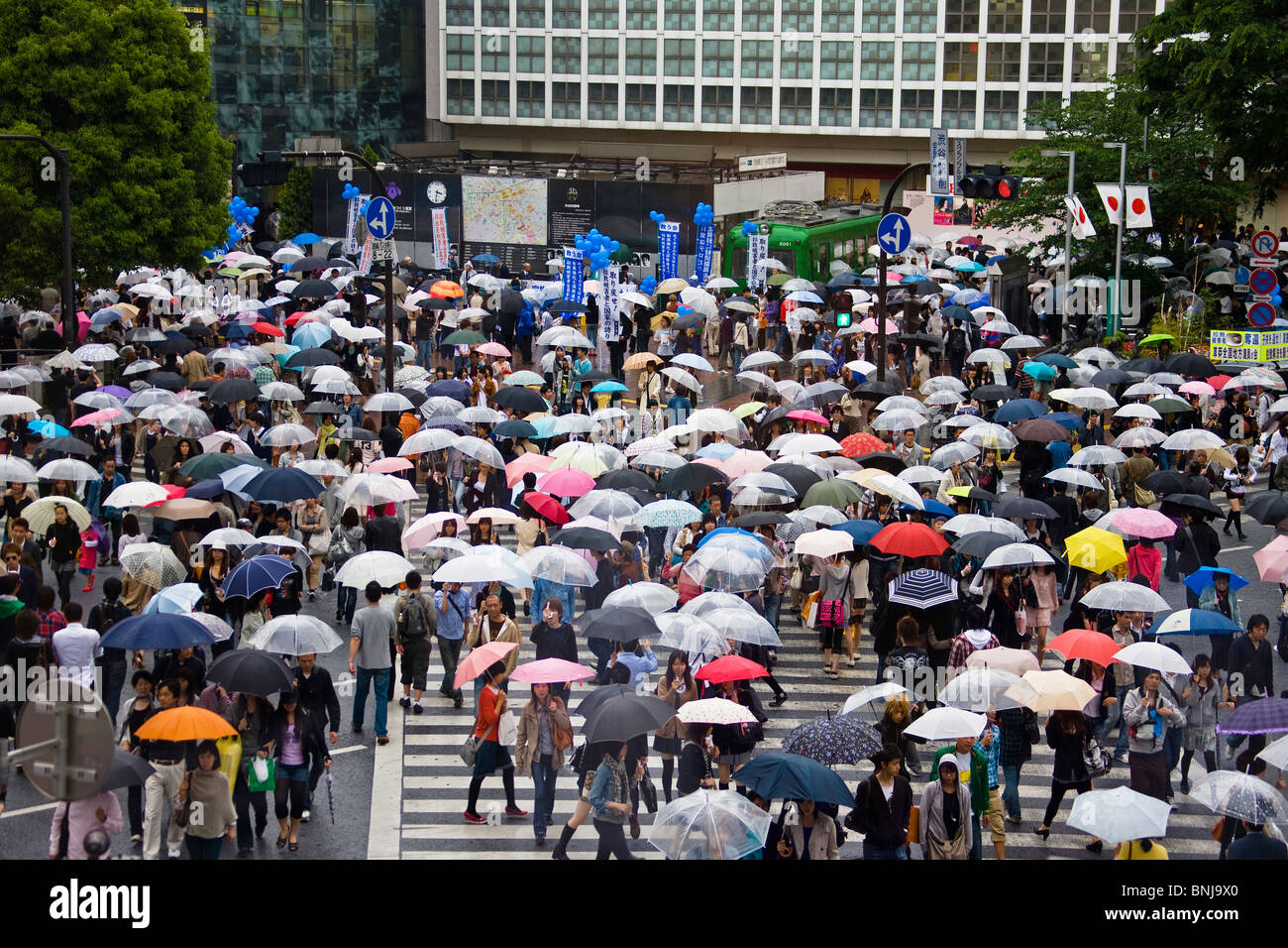 Asia Giappone Tokyo città quartiere Shibuya i passanti da strisce pedonali nelle schermate di pattuglie piogge Foto Stock