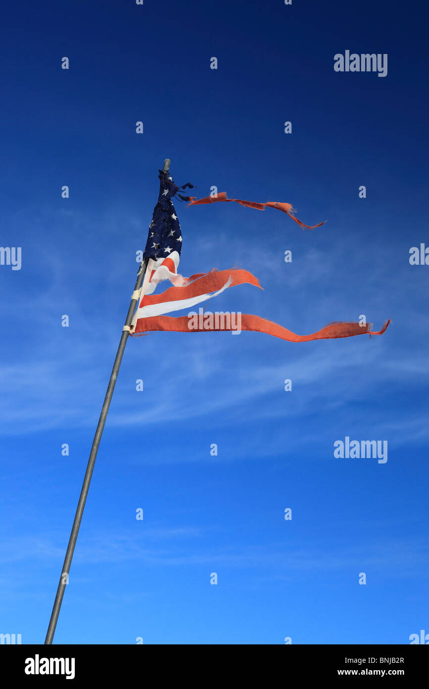 Bandiera degli Stati Uniti bandiera a stelle e strisce Meteo colpite danneggiato cielo blu Weathered simbolo del vento concetto Problema Problemi Foto Stock