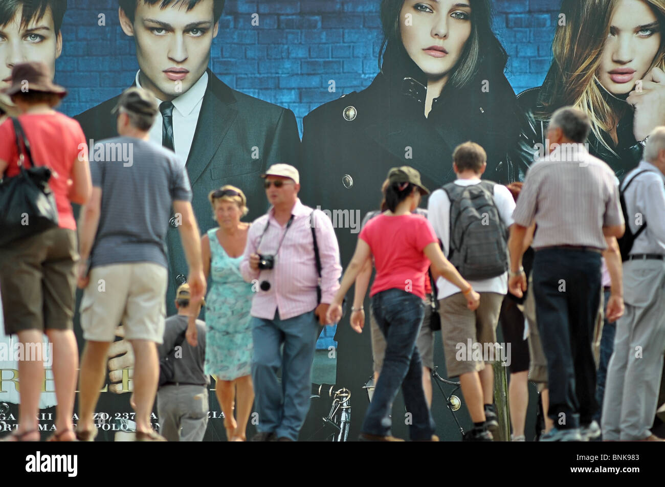 La gente a piedi passato i cartelloni pubblicitari vestiti Burberry, Venezia, Italia Foto Stock