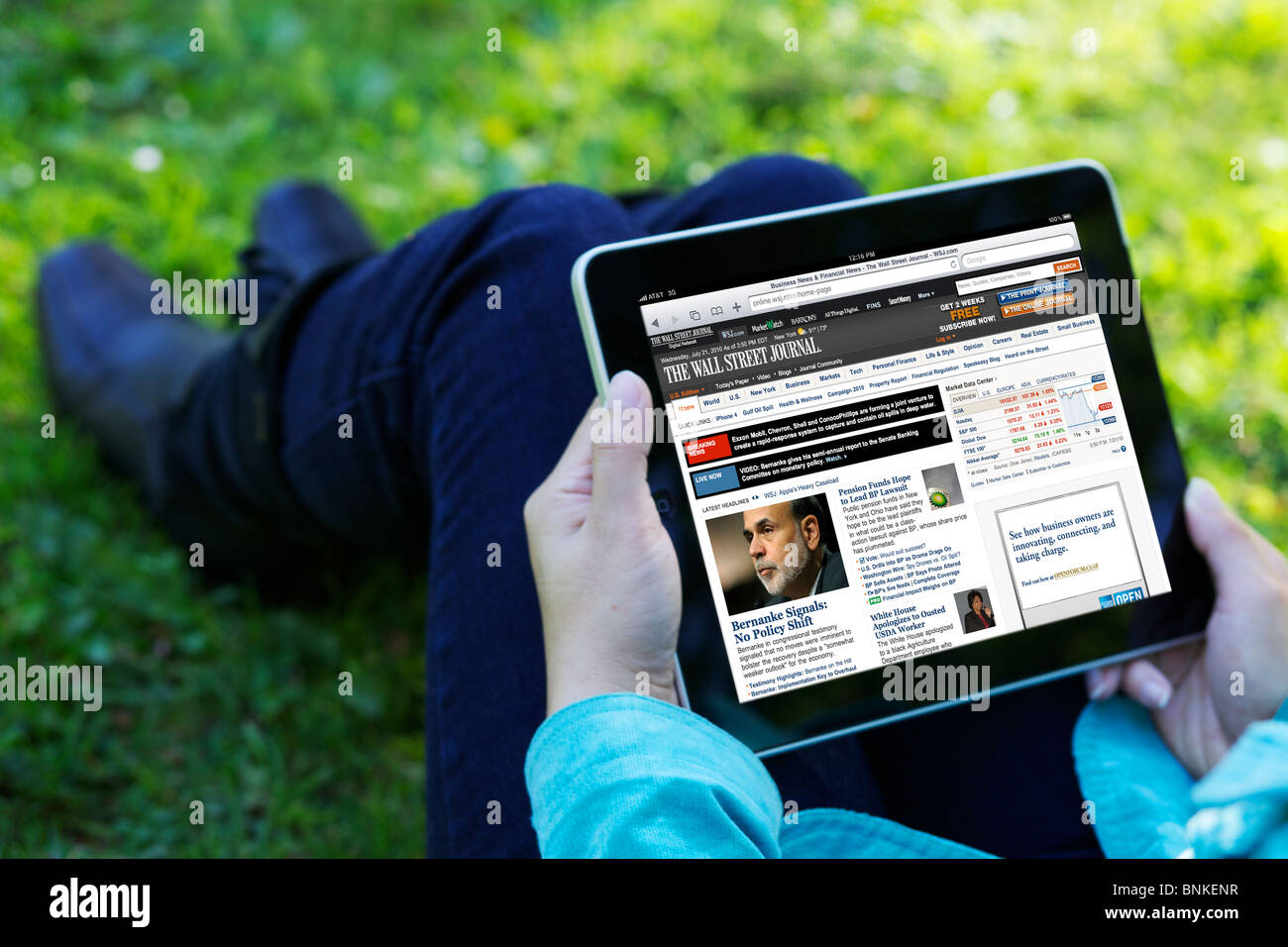 Una donna mano che tiene un iPad durante la lettura del Wall Street Journal online news Foto Stock