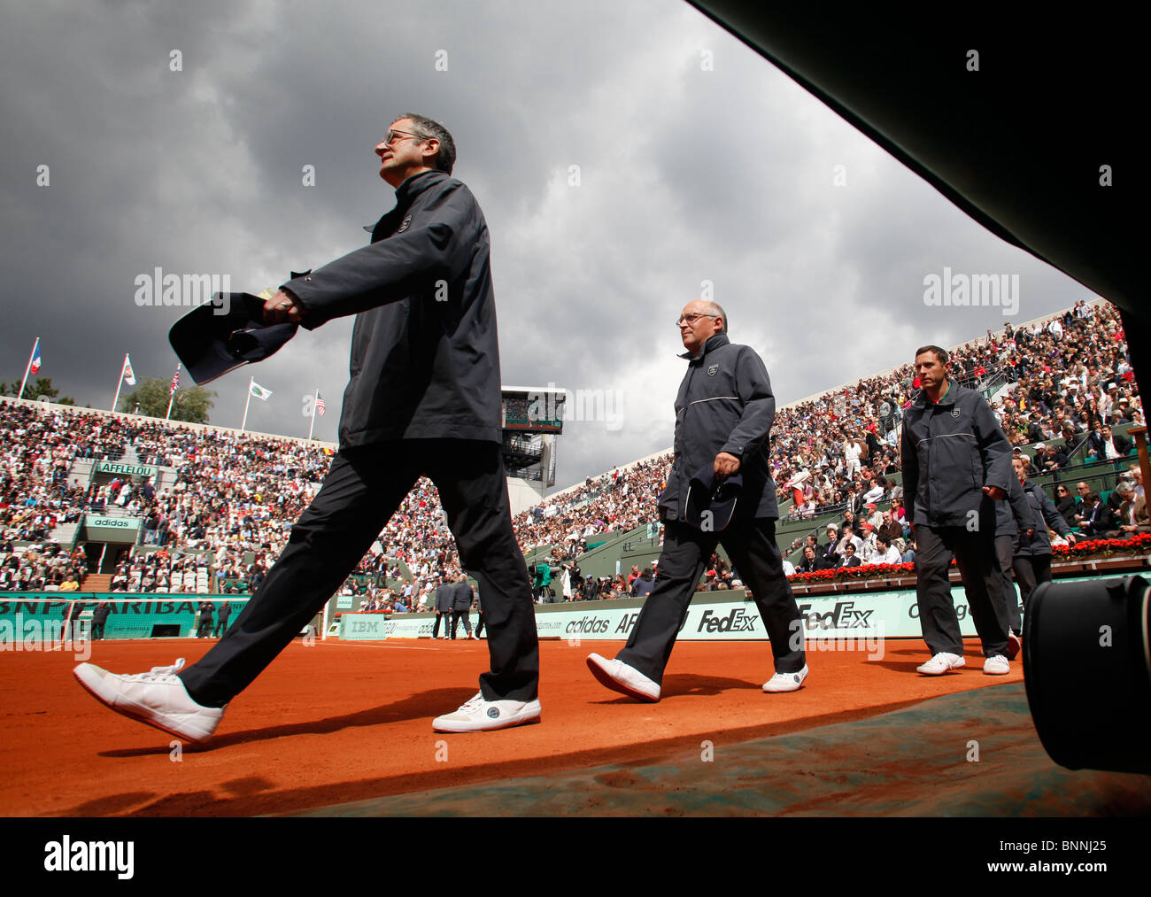 Guardalinee camminando sulla Corte Suzanne-Lenglen al Roland Garros di Parigi Foto Stock