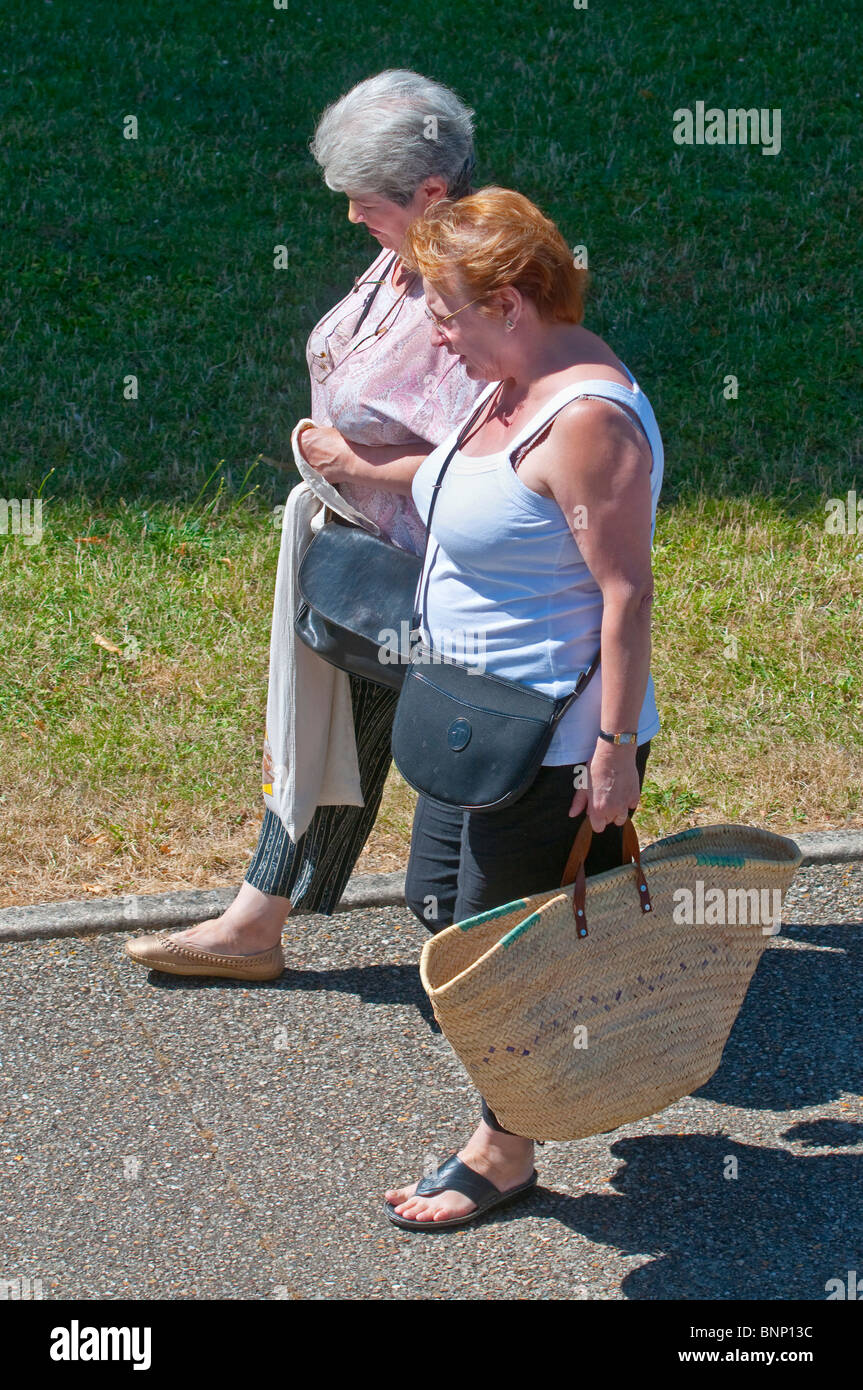 Due maturi, sovrappeso di mezza età le donne a camminare lungo il marciapiede - Francia. Foto Stock