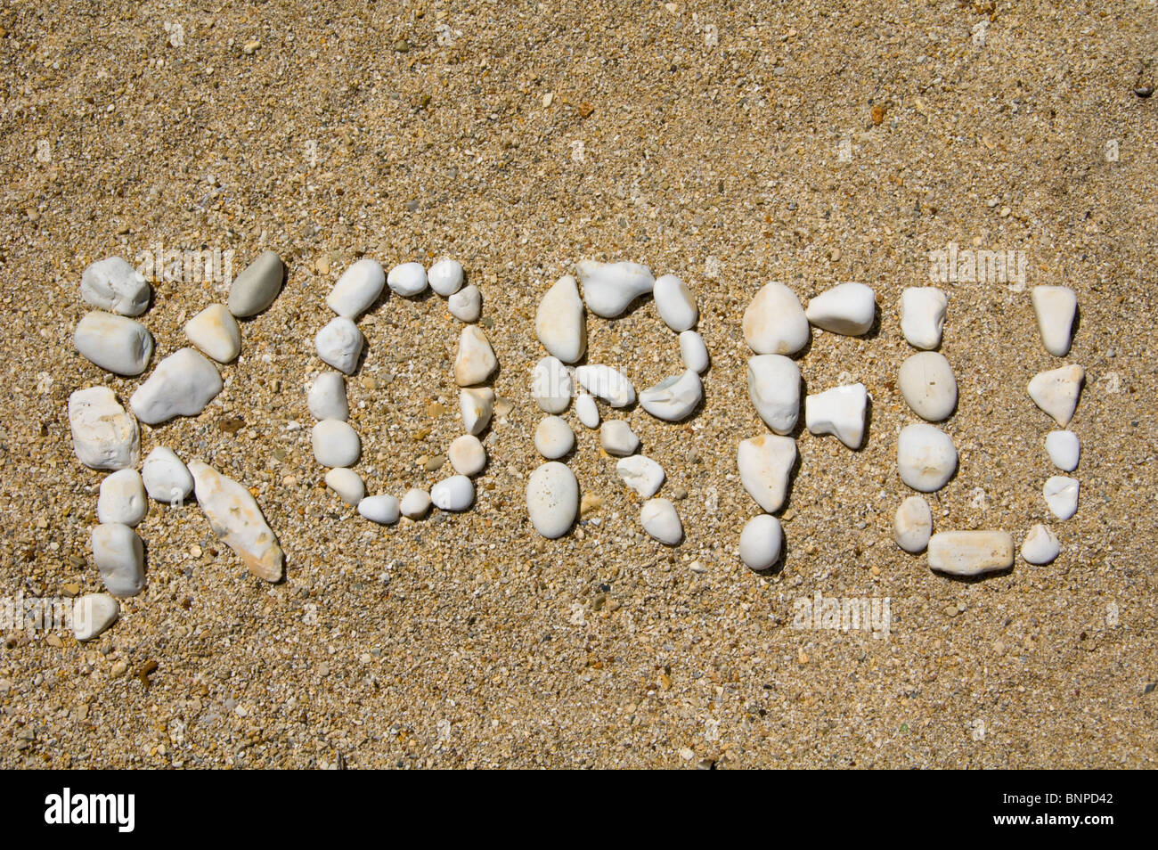 KORFU enunciato in ciottoli su una spiaggia a Kassiopi sul greco dell'isola Mediterranea di Corfu Grecia GR Foto Stock