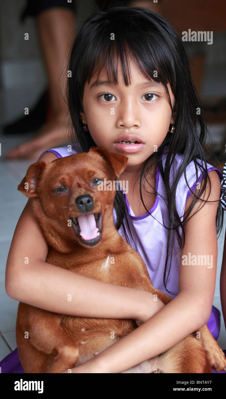 Indonesia Bali Ubud, bambina con il suo cane, Foto Stock