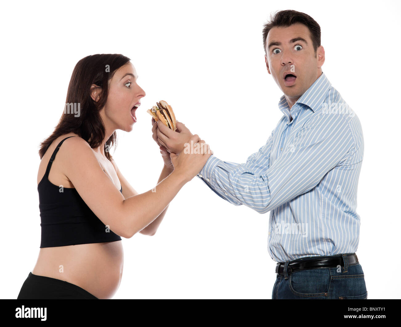 Giovane aspetta il bambino affamato donna mangiare hamburger studio isolato su sfondo bianco Foto Stock