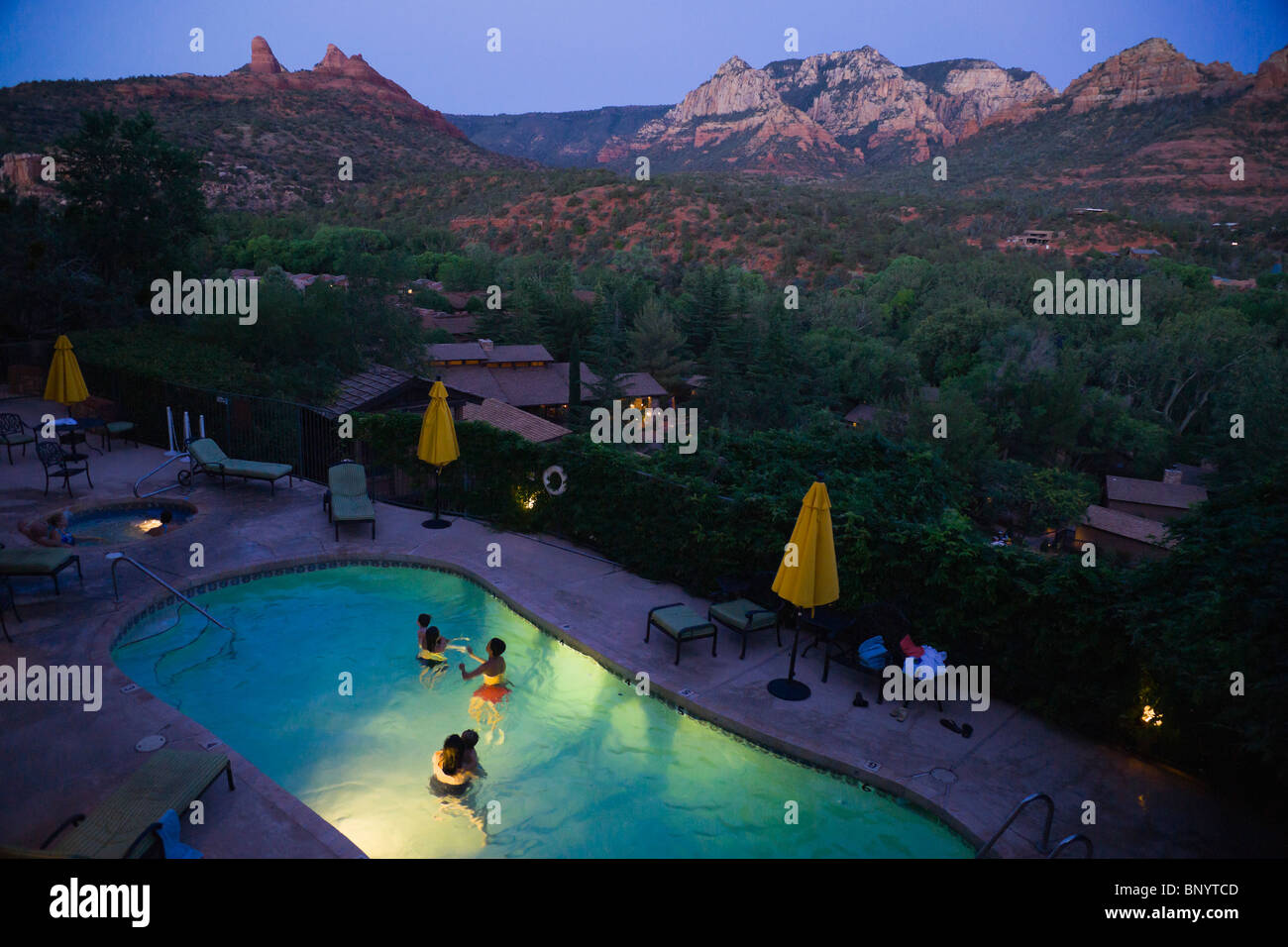 Sedona, in Arizona - Orchard Inn area piscina dal balcone della camera rivolta verso Oak Creek e il Red Rock opinioni. Nuoto dopo il tramonto. Foto Stock