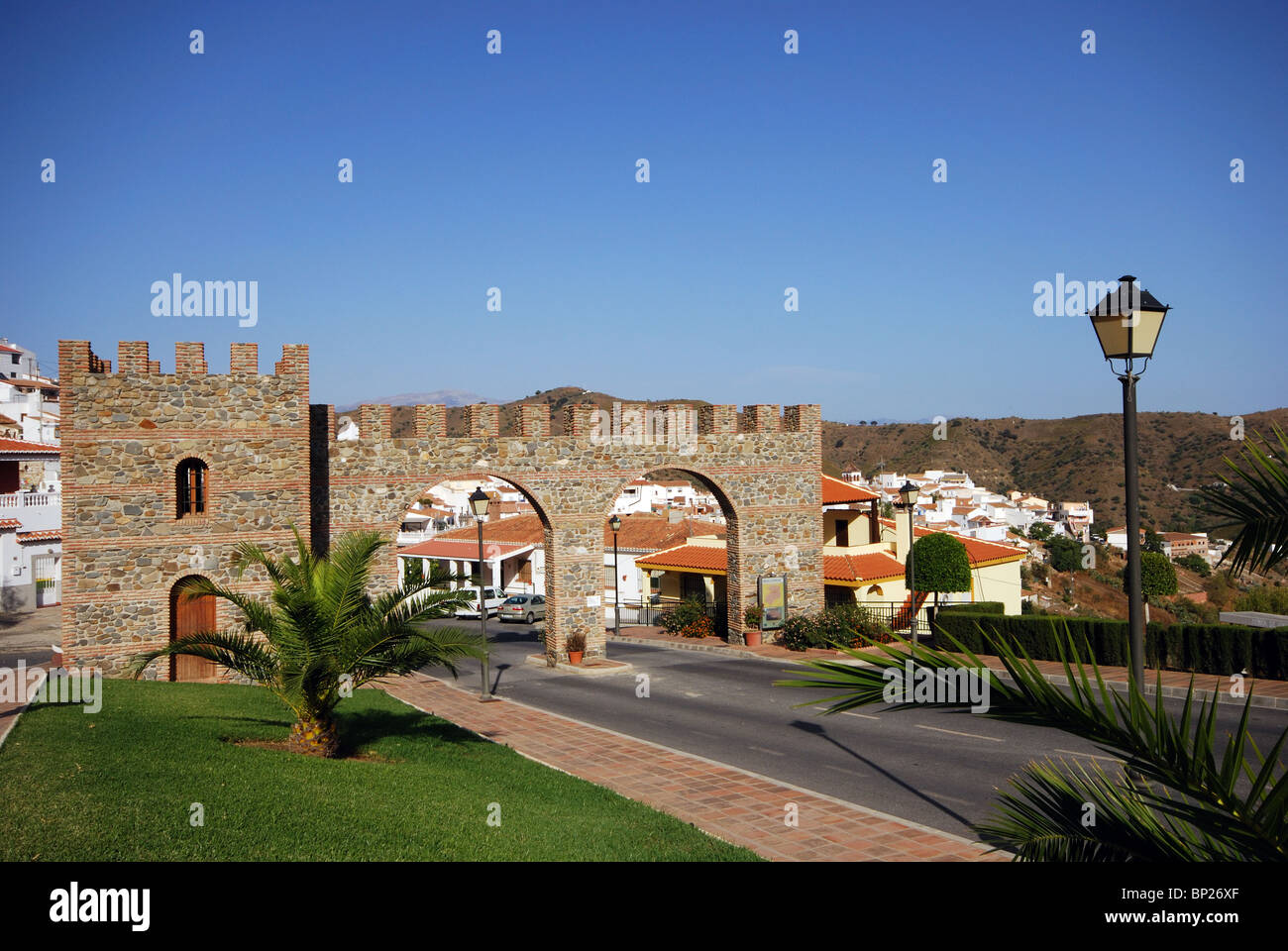 In stile castello arco di ingresso imbiancato village (pueblo blanco), Moclinejo, Costa del Sol, provincia di Malaga, Andalusia. Foto Stock