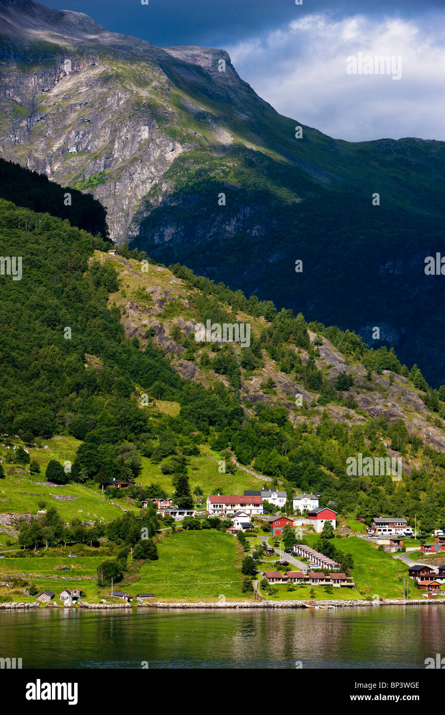 Norvegia Geiranger Geirangerfjord fiordo paesaggio solare case acqua tranquilla montagna villaggio homlong ritratto con spazio di copia Foto Stock