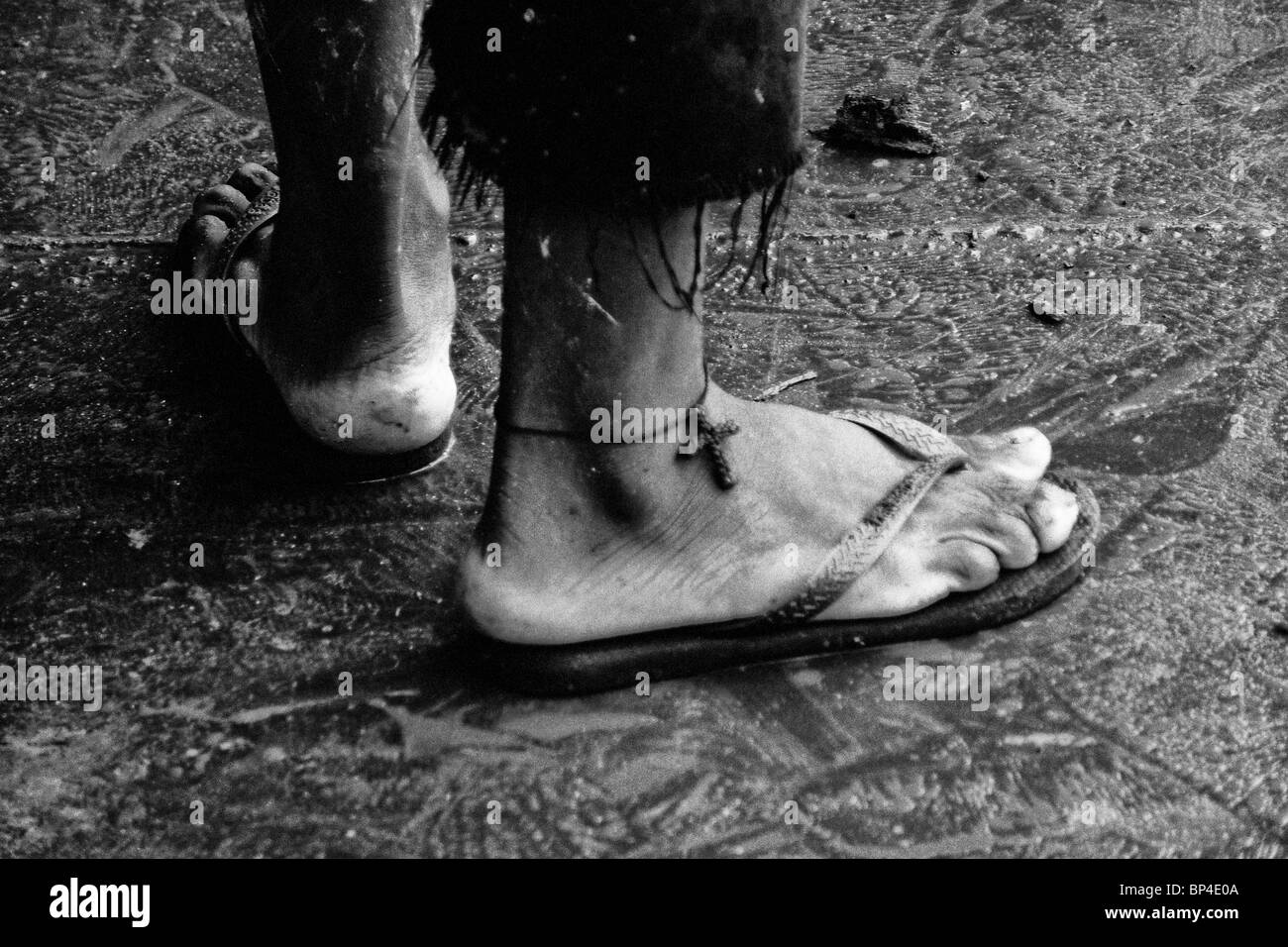 Un uomo brasiliano avente la croce cristiana simbolo sulla sua caviglia come una protezione contro l'annegamento nel fiume. Foto Stock