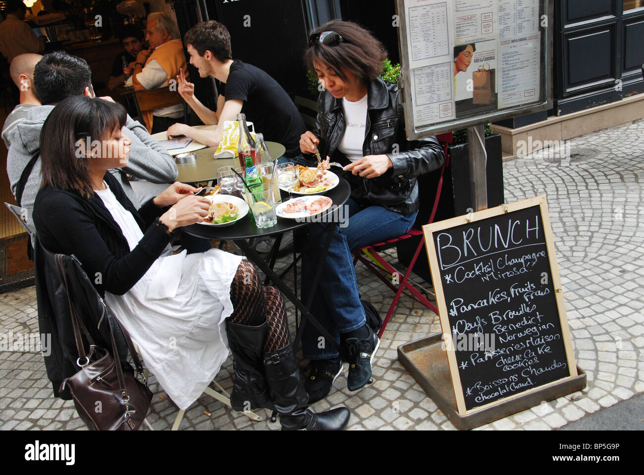 Avere un pasto presso il ristorante parigino, Parigi Francia Foto Stock