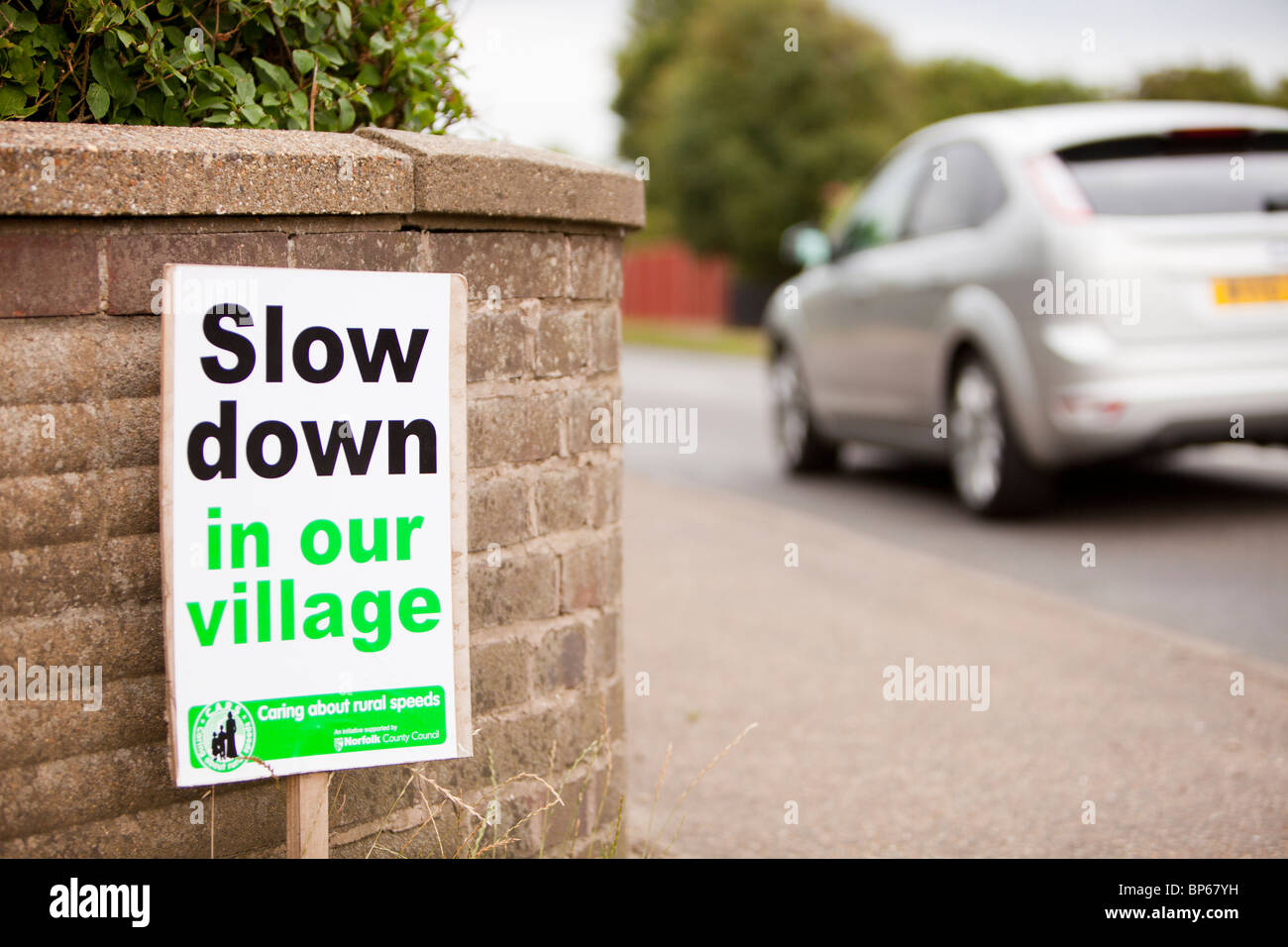 Un segno chiedendo agli automobilisti di rallentare in Mundesley villaggio in Norfolk, Regno Unito. Foto Stock