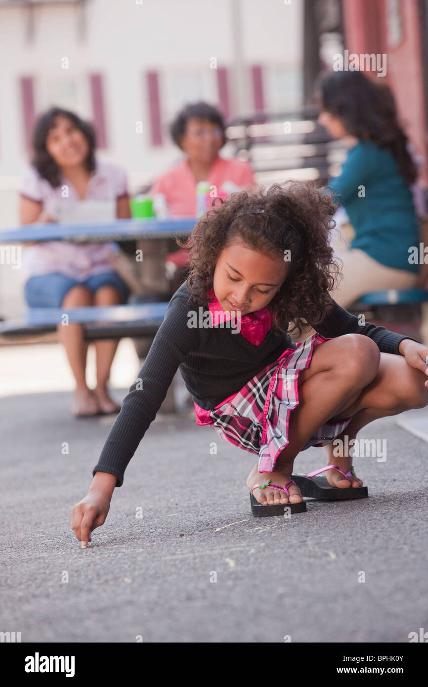Ragazza ispanica disegno sul pavimento con un gessetto, Boston, Massachusetts, STATI UNITI D'AMERICA Foto Stock