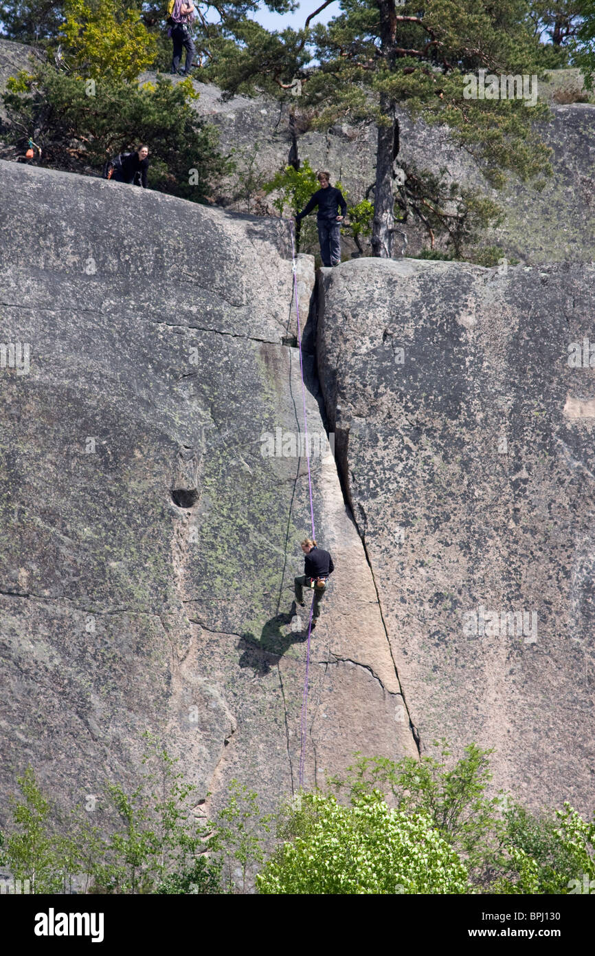 Gli arrampicatori Mouontain sul ripido fianco della montagna di Simonsberget, Tunaberg, Svezia. Foto Stock