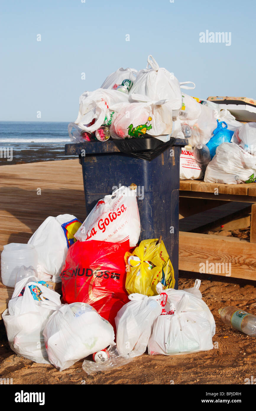 Traboccante bidone con ruote sulla spiaggia in Spagna Foto Stock