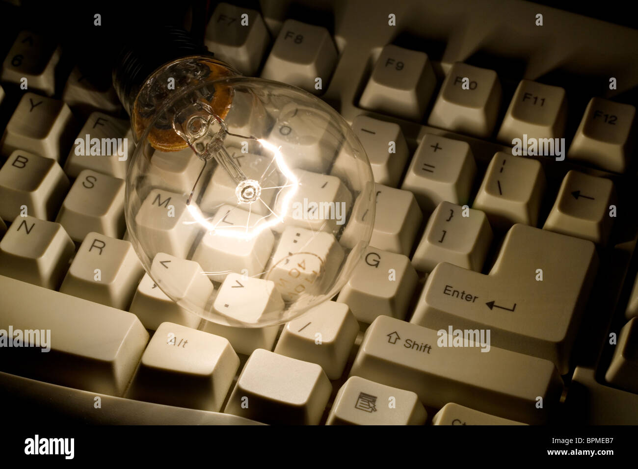 La lampadina della spia e la tastiera del computer immagine ravvicinata Foto Stock