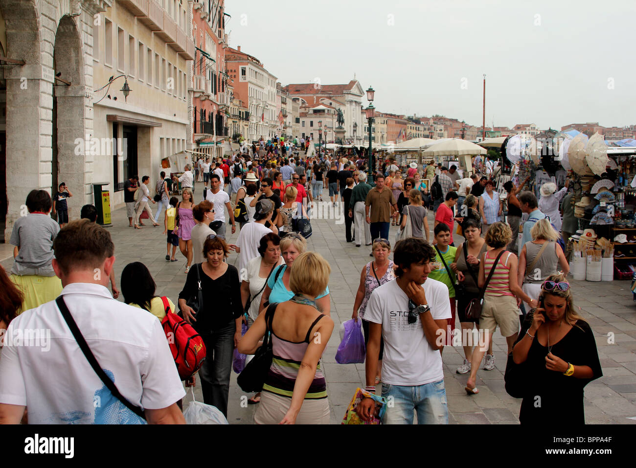 Ogni anno milioni di turisti a visitare Venezia in Italia e si tratta di alcuni di essi sul marciapiede lungo il Canal Grande Foto Stock