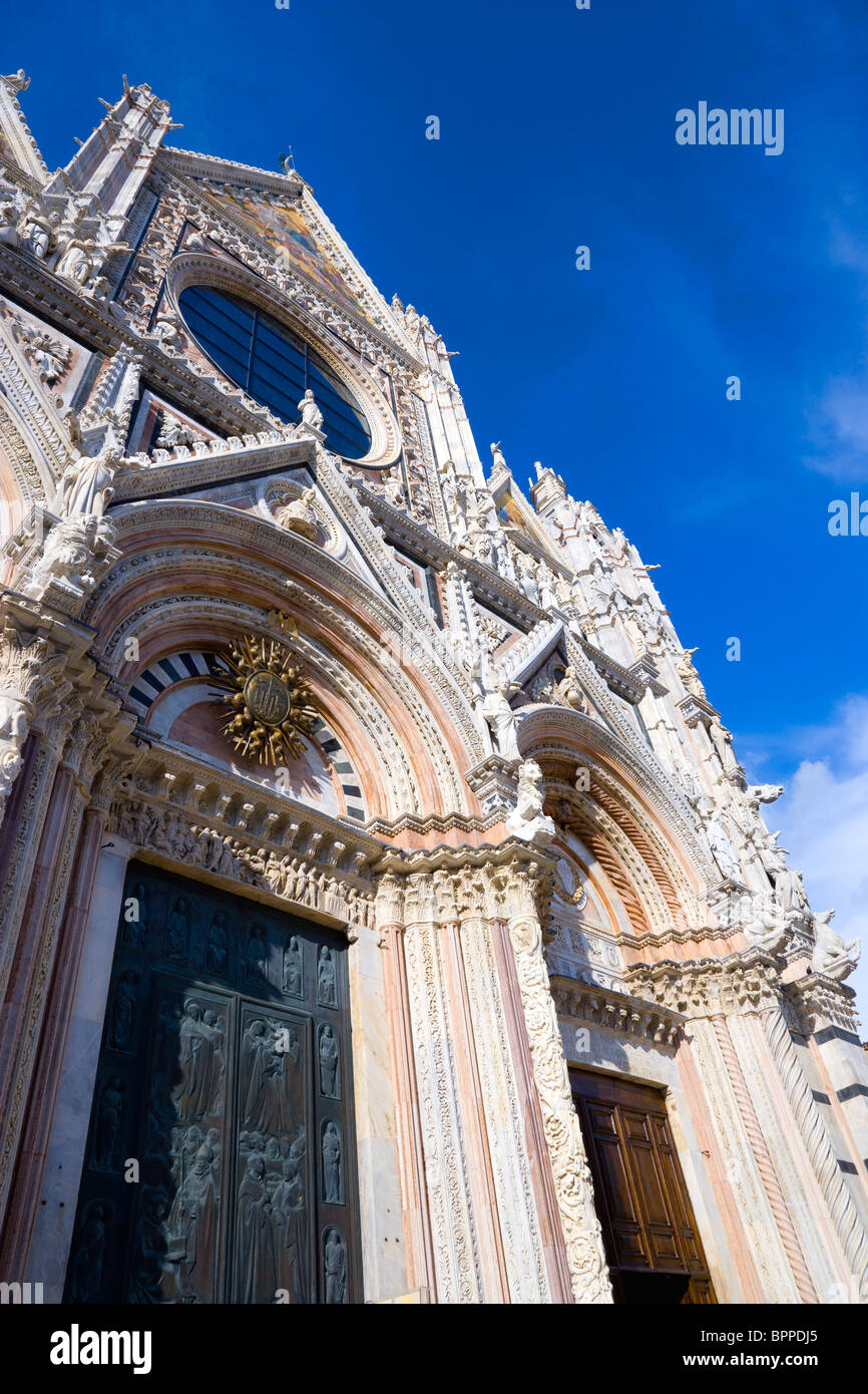 Italia Toscana Siena La rosa di marmo bianco e nero facciata del Duomo chiesa di Santa Maria Assunta sotto un cielo blu Foto Stock