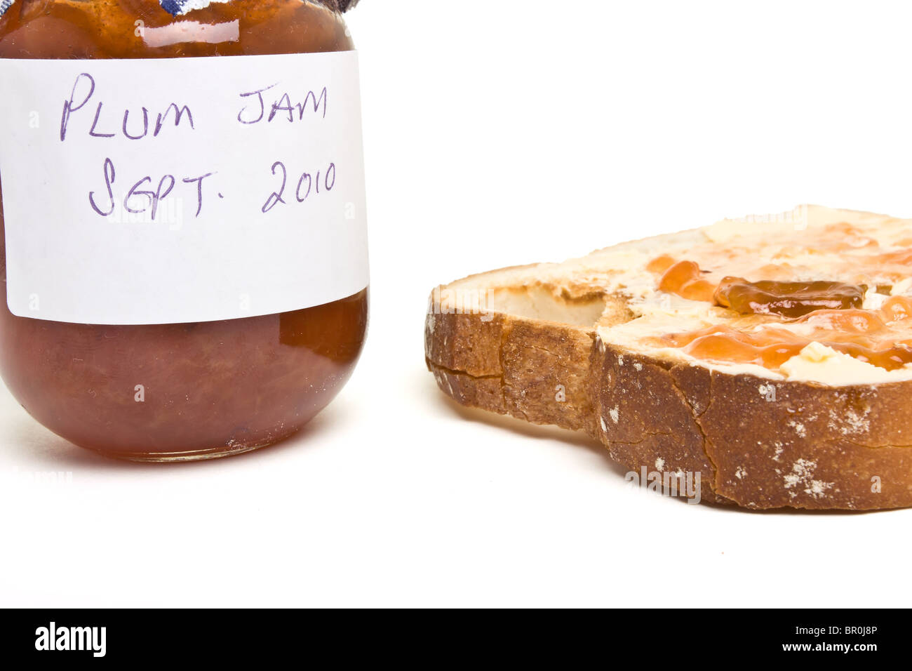 In casa di marmellata di prugne con fette di pane tostato e burro. Foto Stock